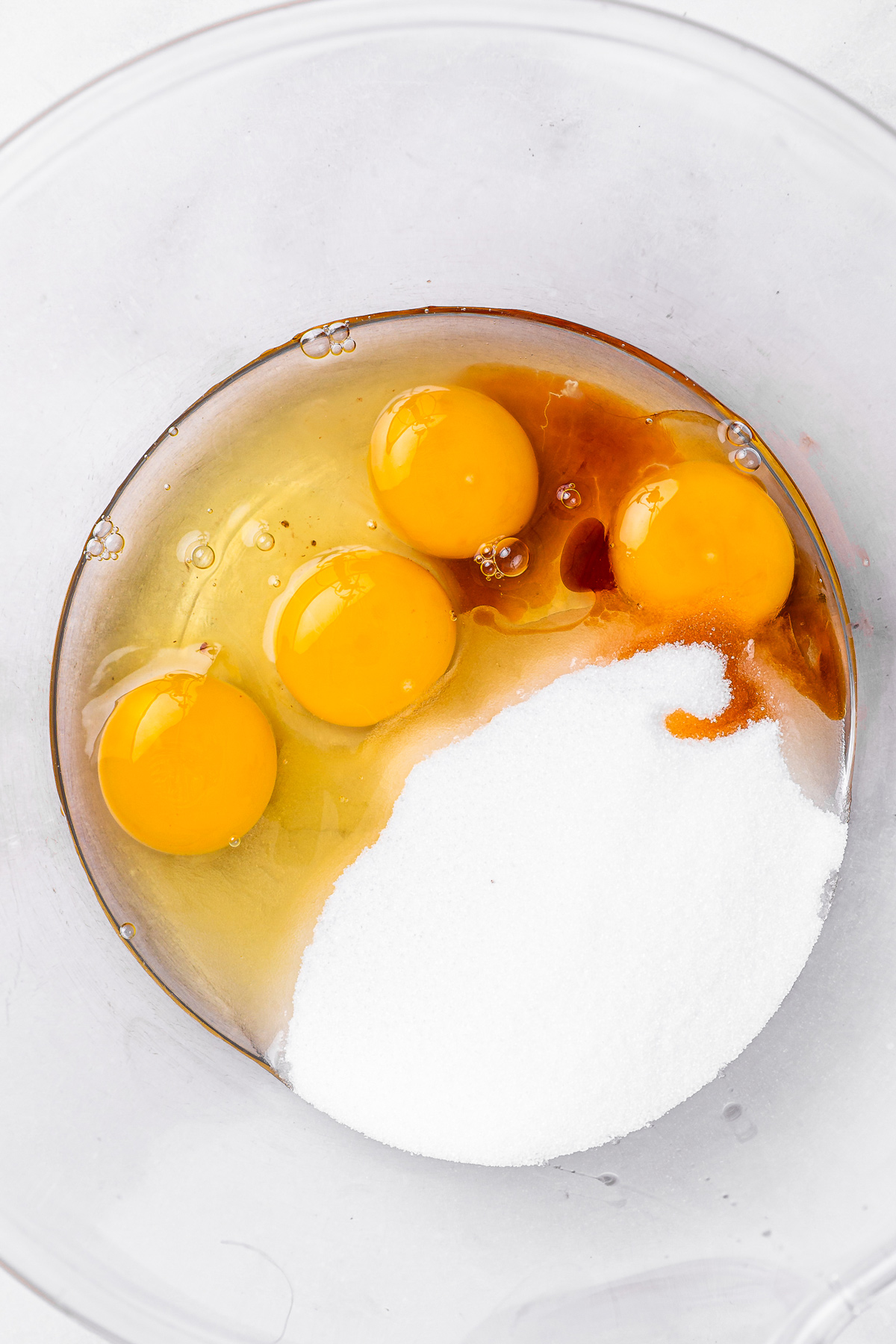 eggs sugar and vanilla whisked in a bowl