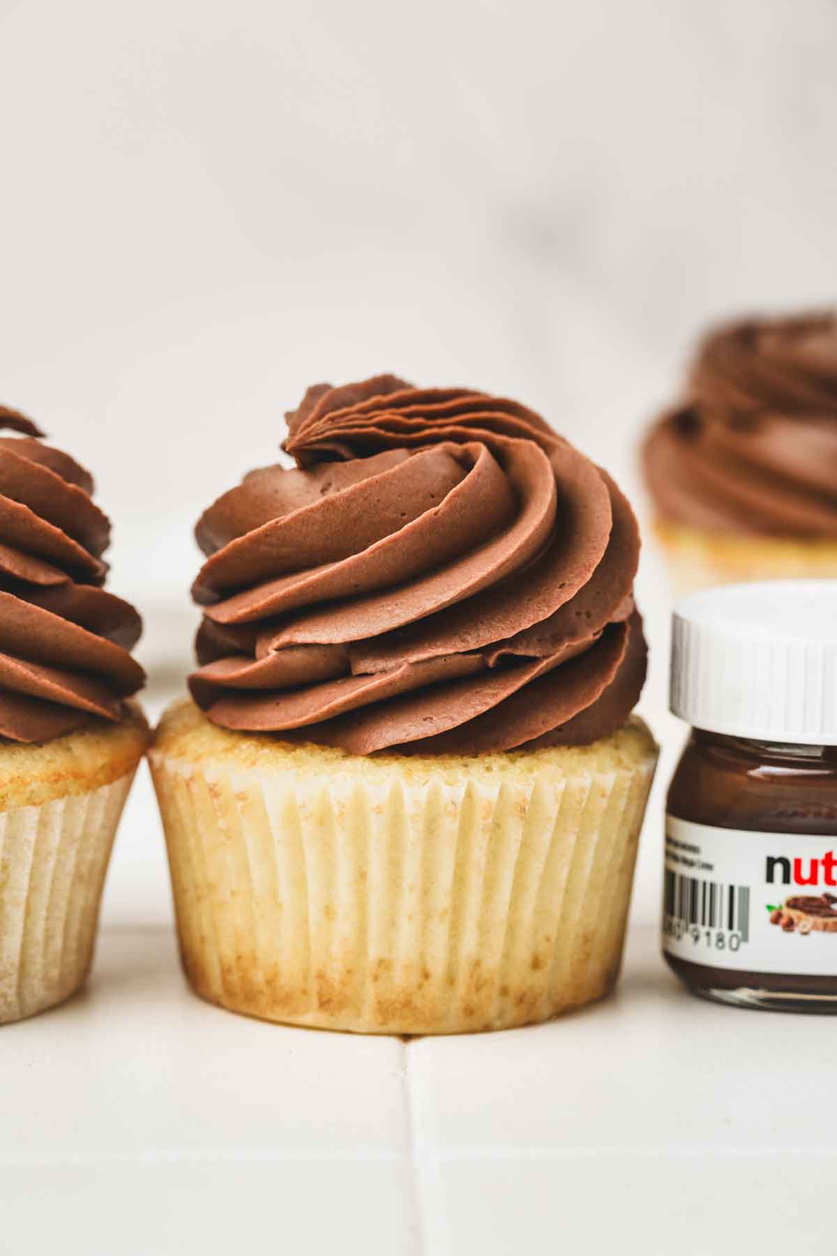 cupcakes on a table with a nutella ganache frosting