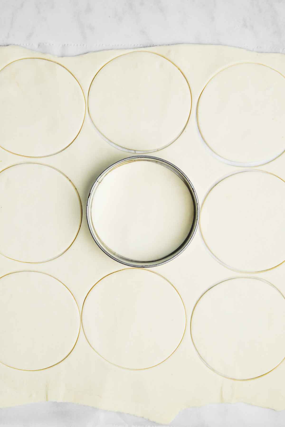 spread out puff pastry dough with a round cutter