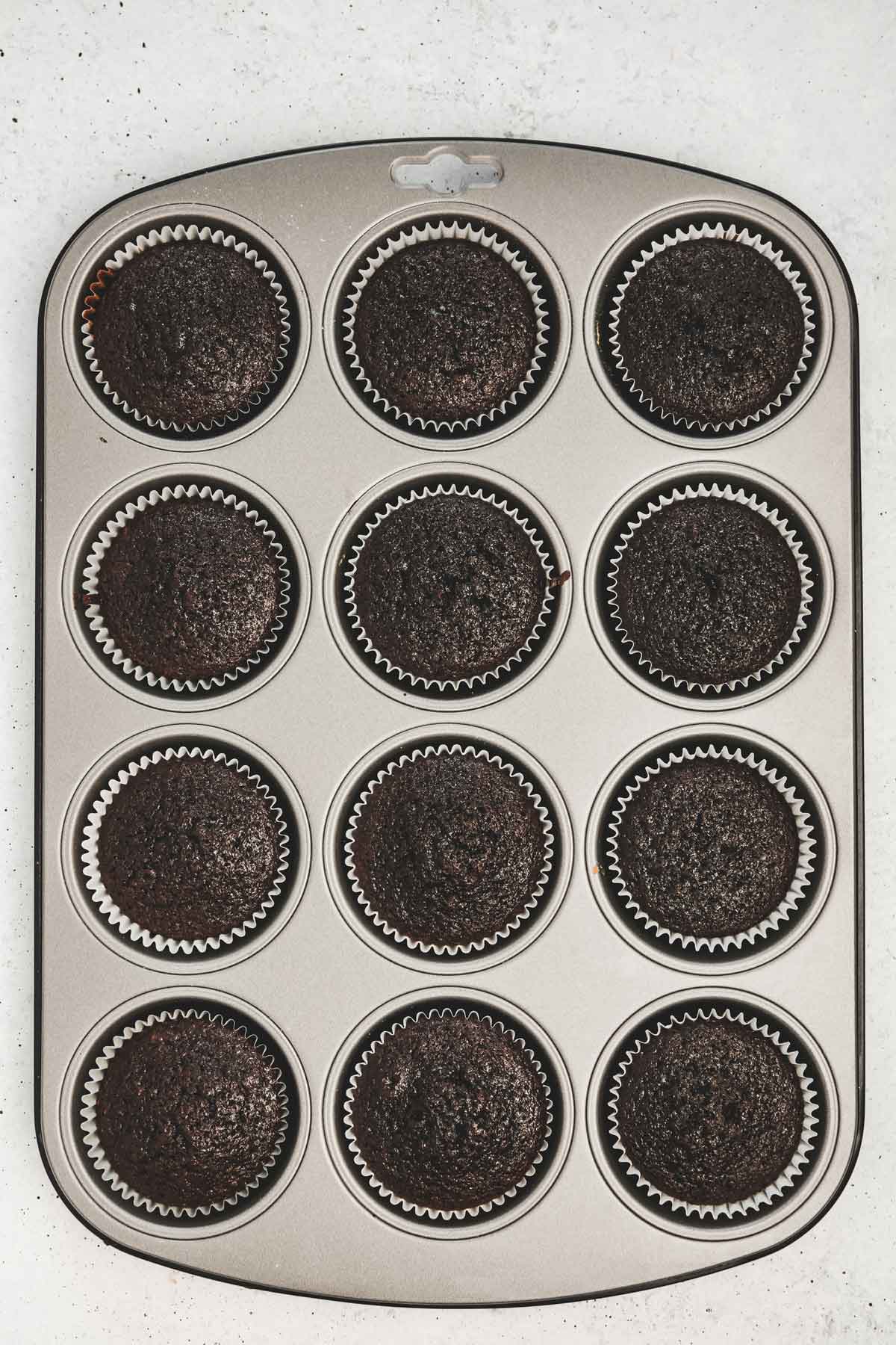 muffins pan with baked chocolate cupcakes