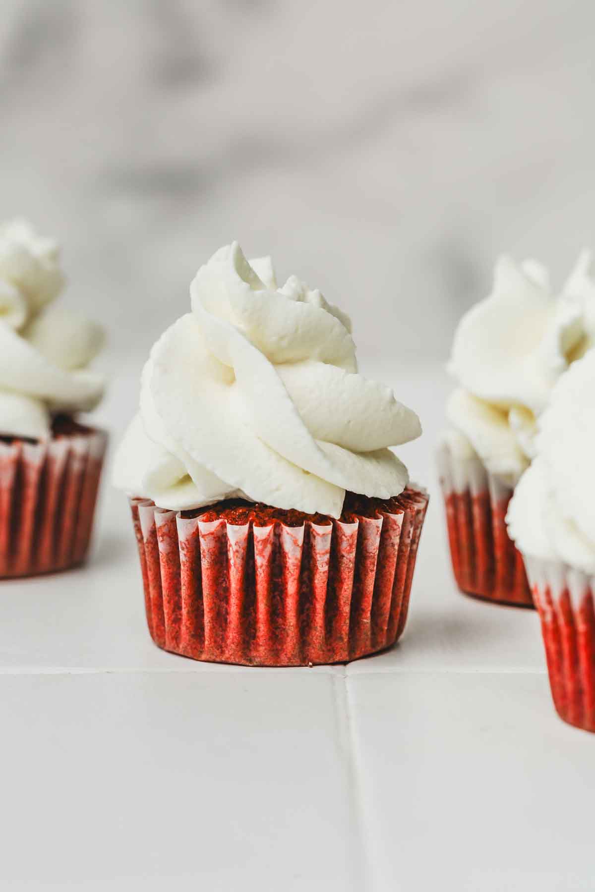 mini cupcakes with whipped ceam and cream cheese topping