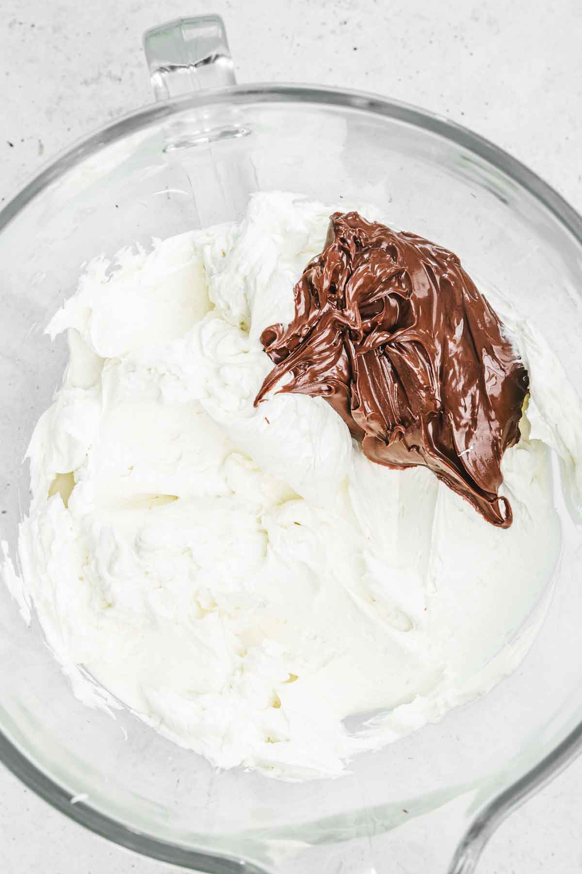 large mixing bowl with meringue with nutella spread