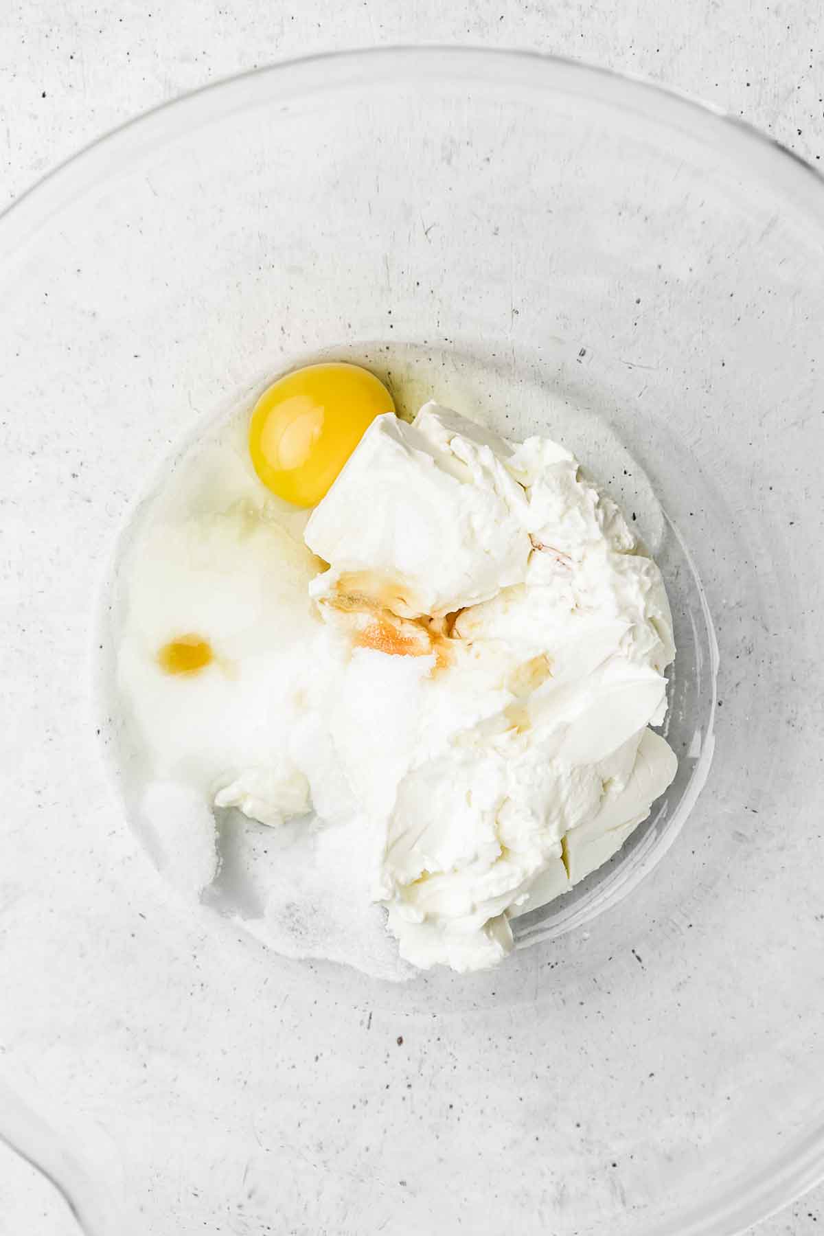 mixing bowl with cream cheese and egg 