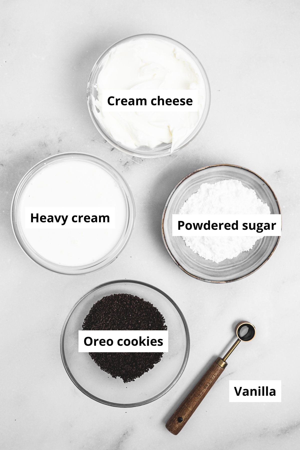 ingredients for oreo cream cheese frosting in small bowls