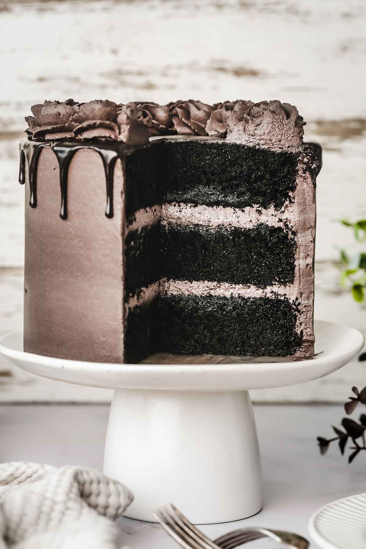 sliced black chocolate cake on a cake stand