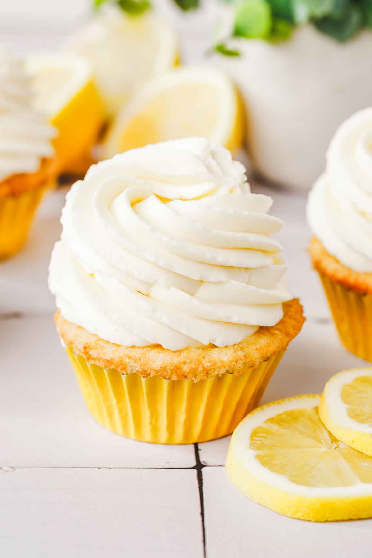 cupcakes in table topped with lemon mascarpone whipped cream frosting