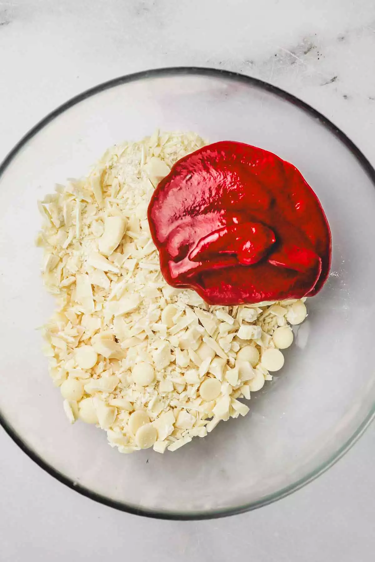 medium bowl with chopped white chocolate and raspberry puree