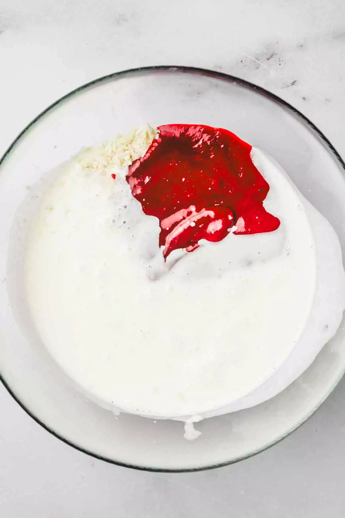 medium bowl with raspberry puree and hot heavy cream
