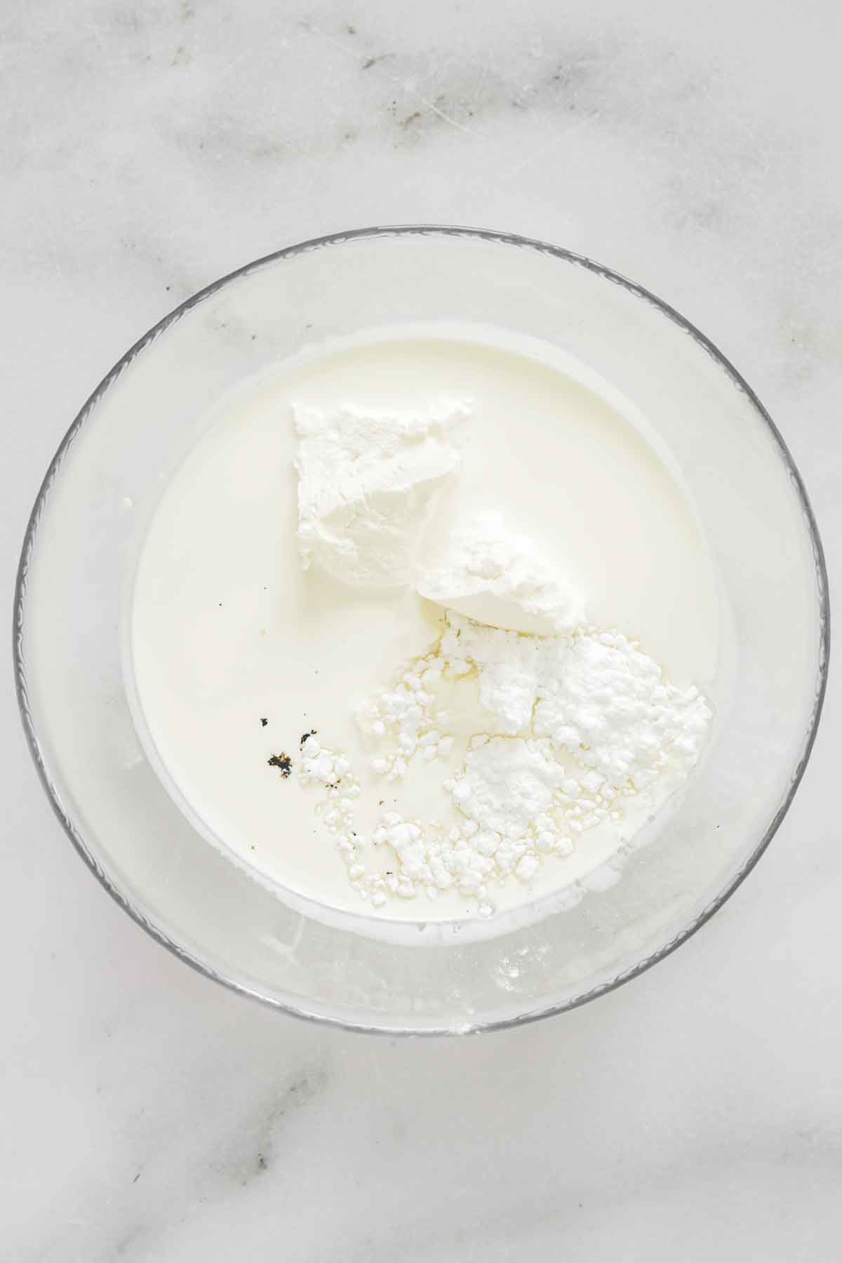 mixing bowl with heavy cream and mascarpone cheese