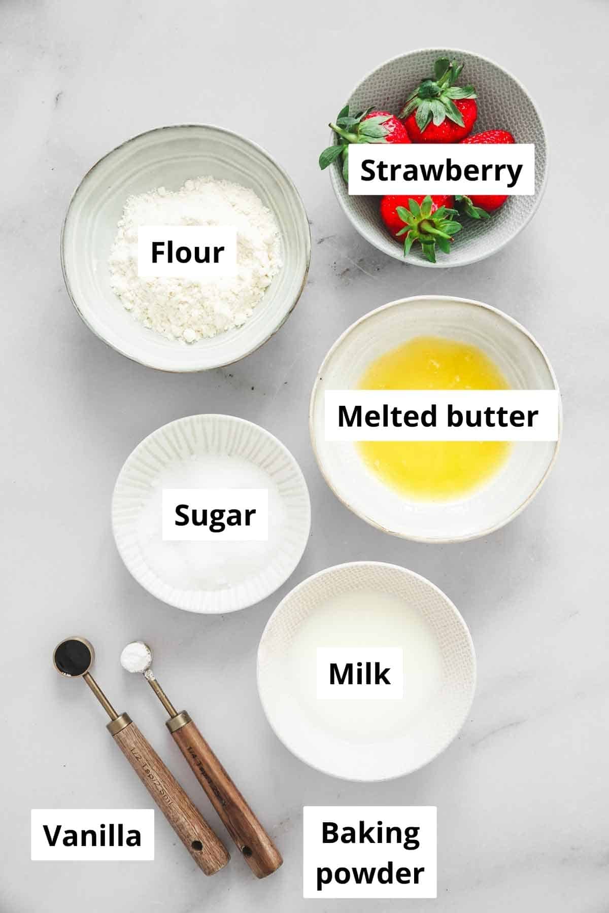 ingredients for strawberry mug cake in small bowls
