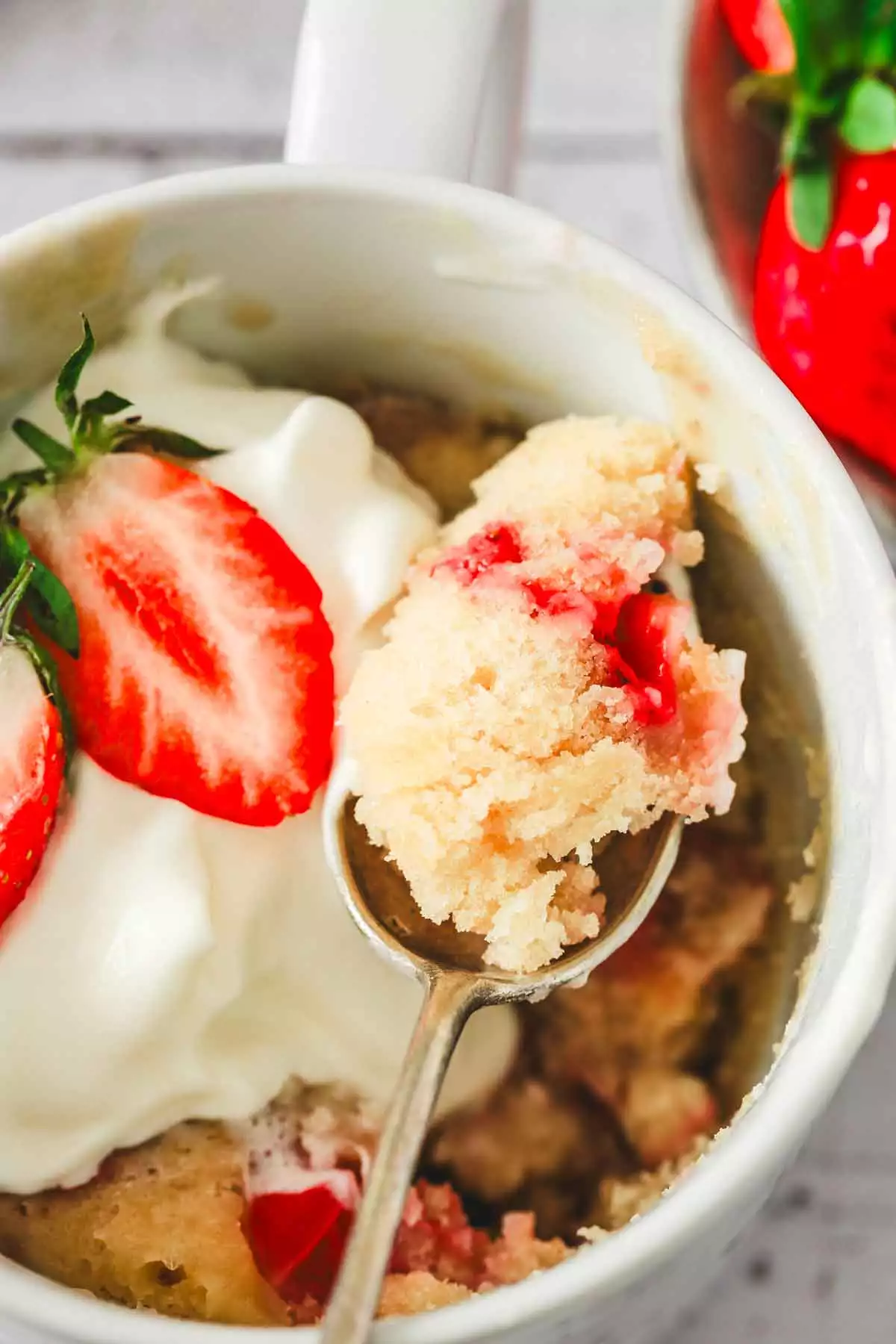 strawberry mug cake thumbnail with whipped topping
