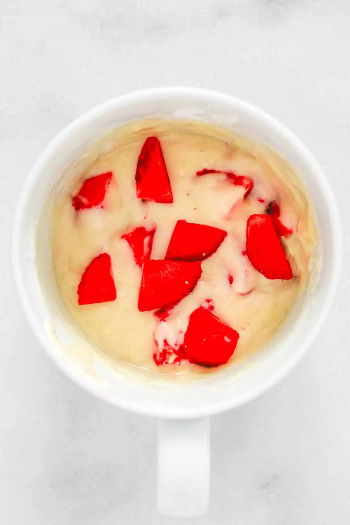 strawberry mug cake batter mixed in coffee mug
