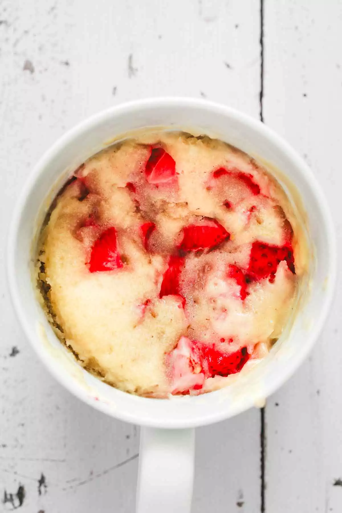 cooked strawberry mug cake in microwave-safe mug
