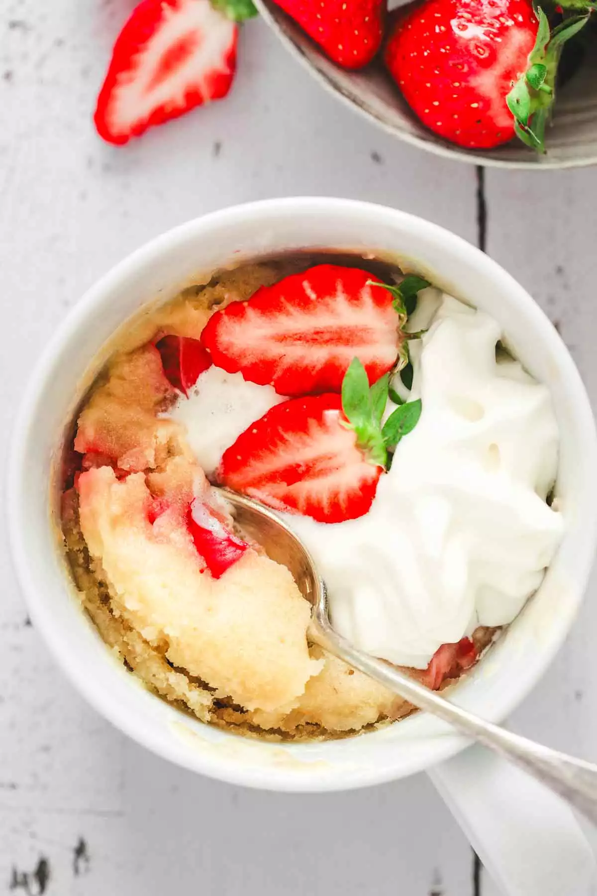 easy strawberry mug cake served on a table
