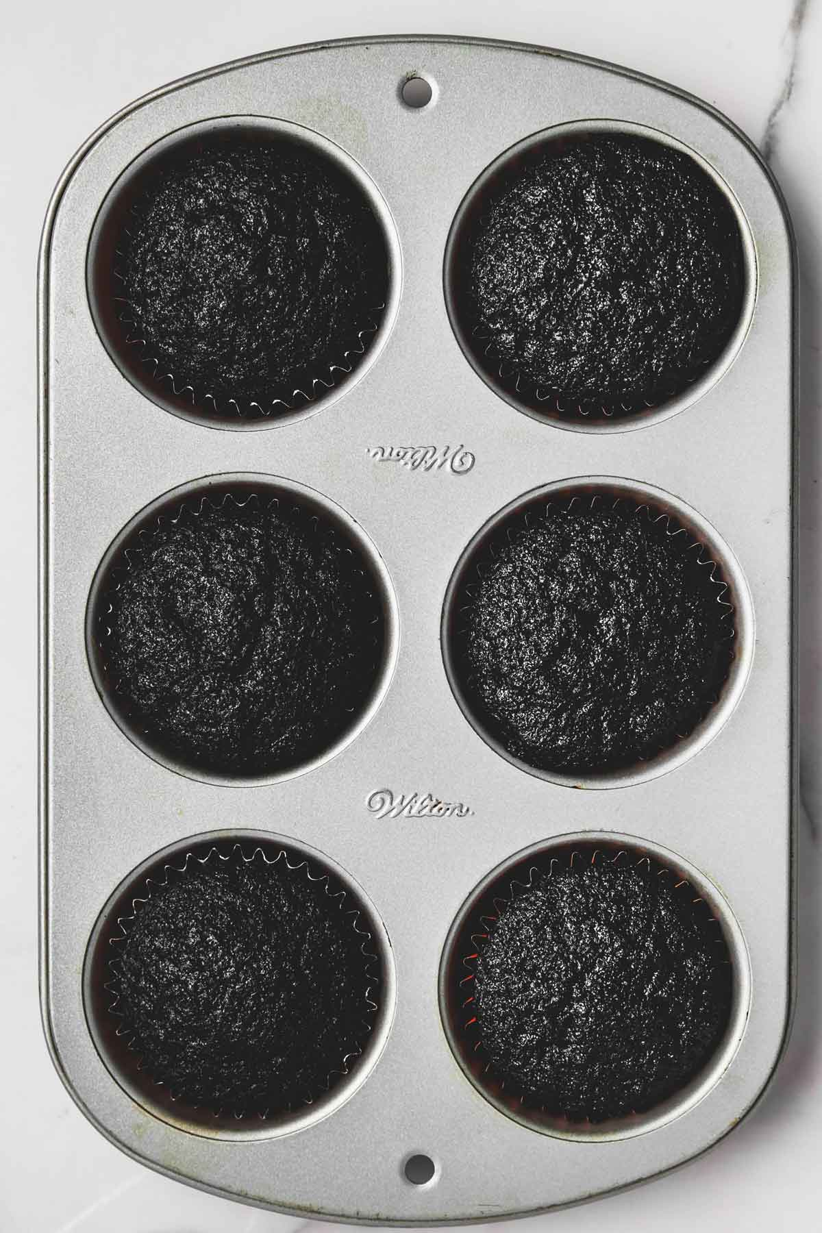 cupcake pan with black cocoa cupcakes