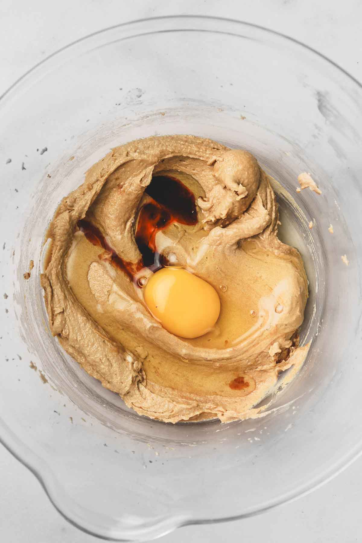 mixing bowl with creamed butter and a egg