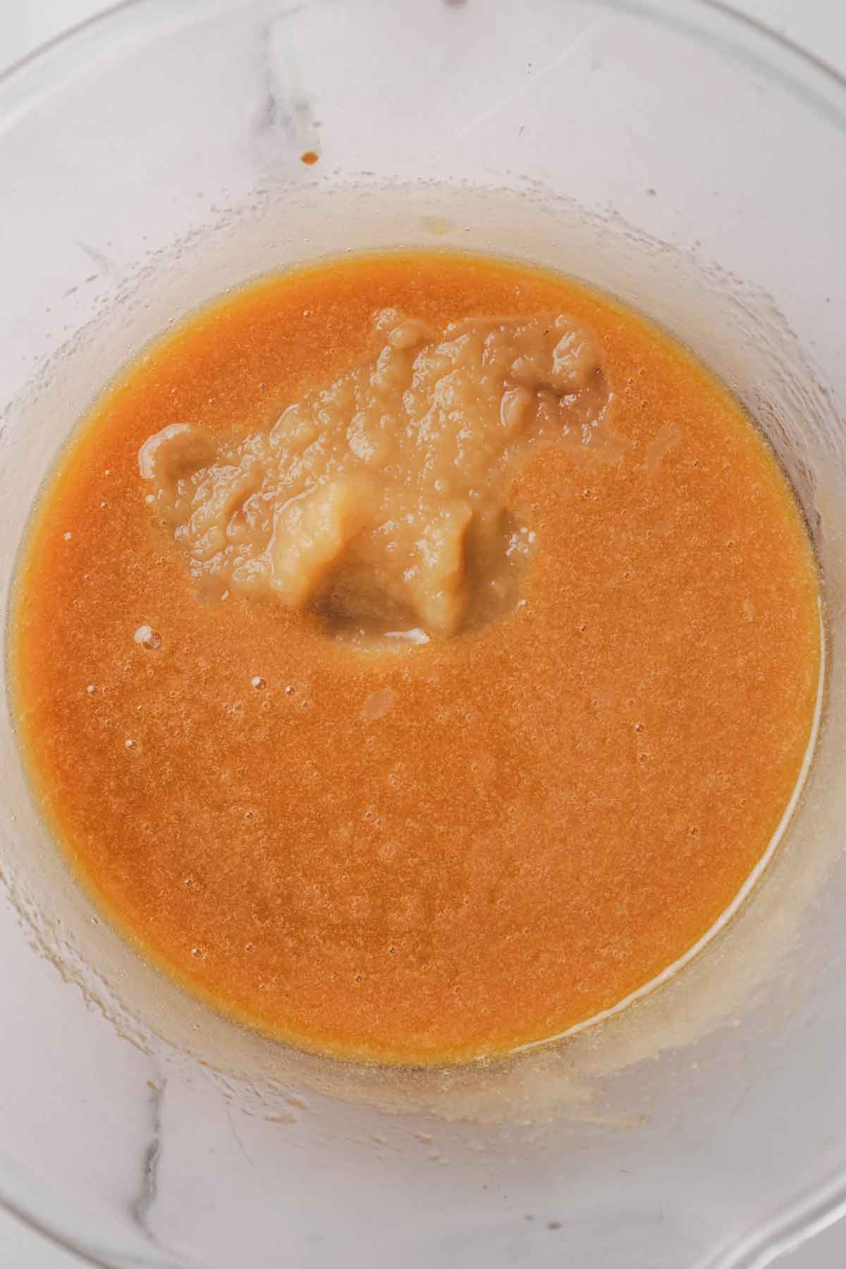 mixing bowl with cake batter and apple sauce