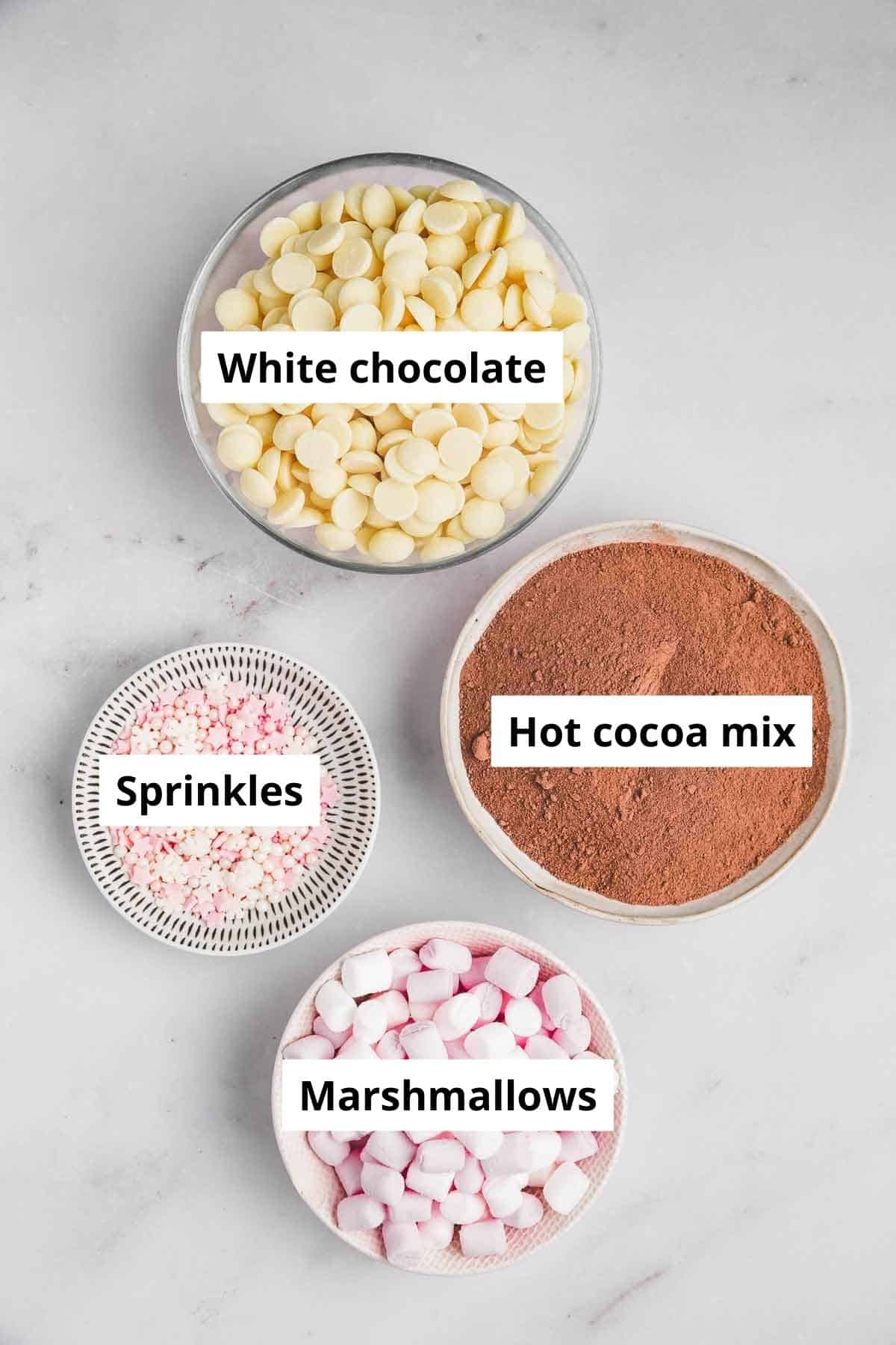 bowls with ingredients to make hot chocolate bomb recipe with white chocolate