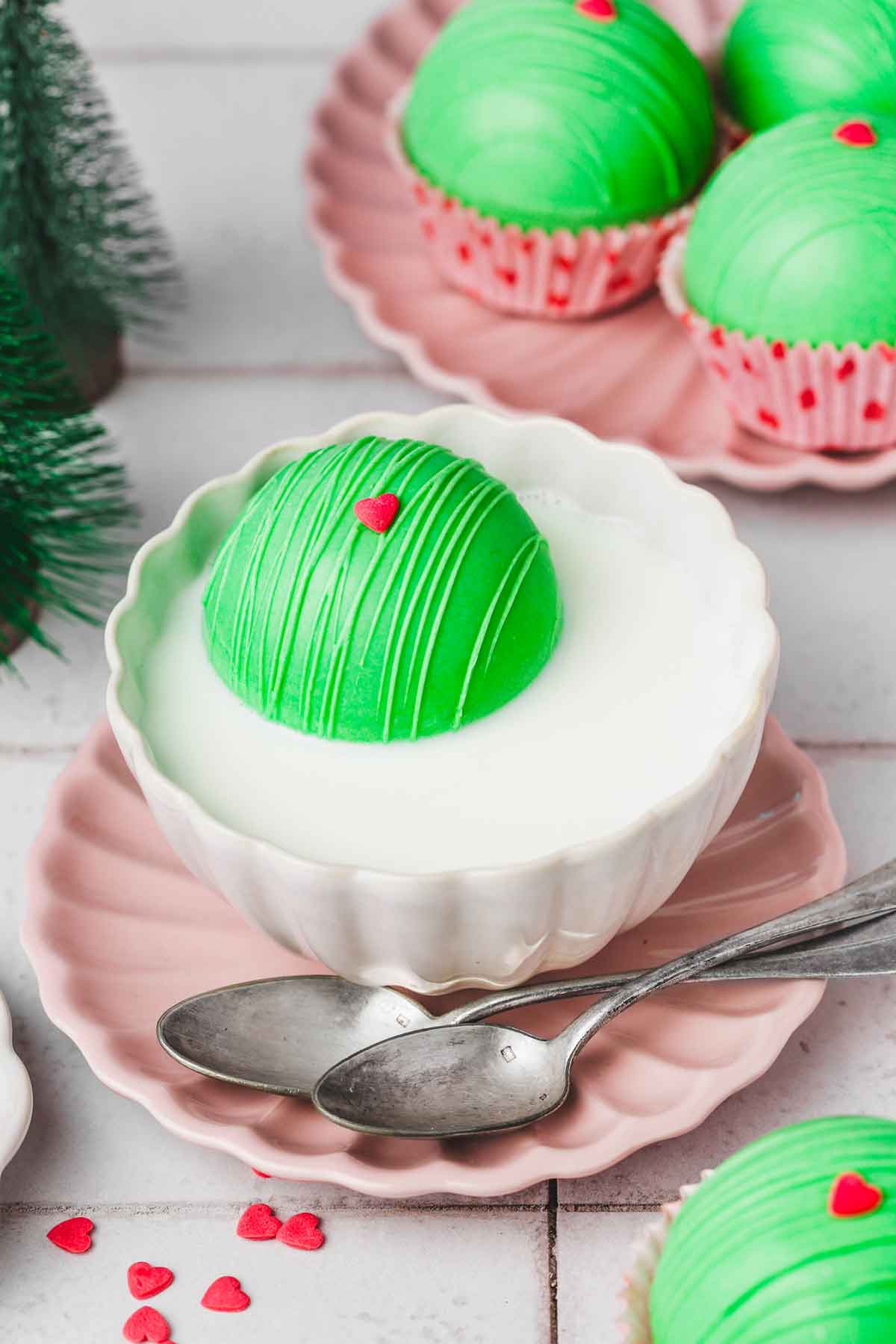 cup of milk with a grinch cocoa balls