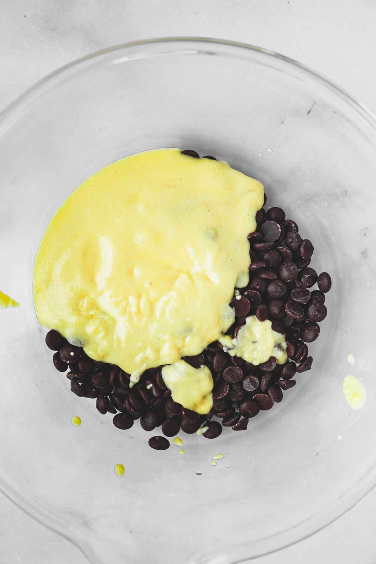 mixing bowl with chopped chocolate with hot custard
