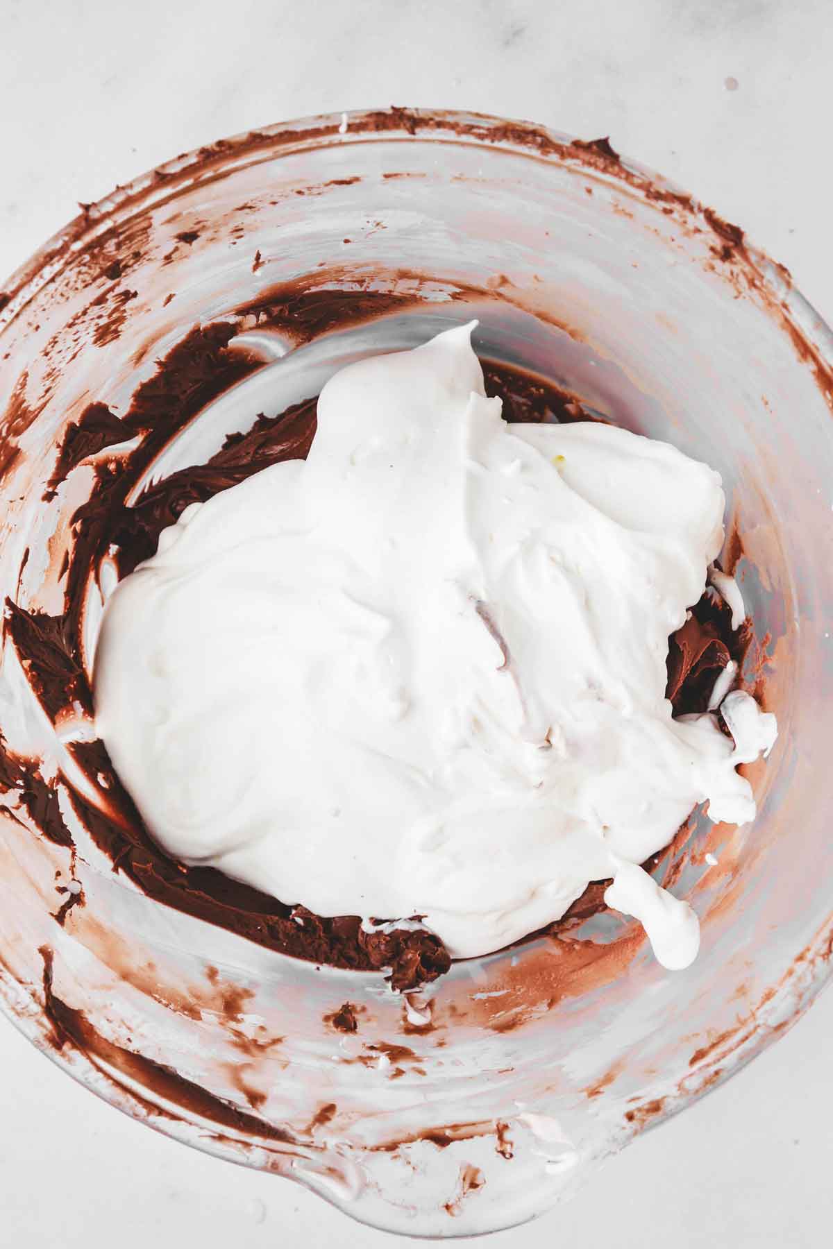 large mixing bowl with chocolate mixture and whipped cream