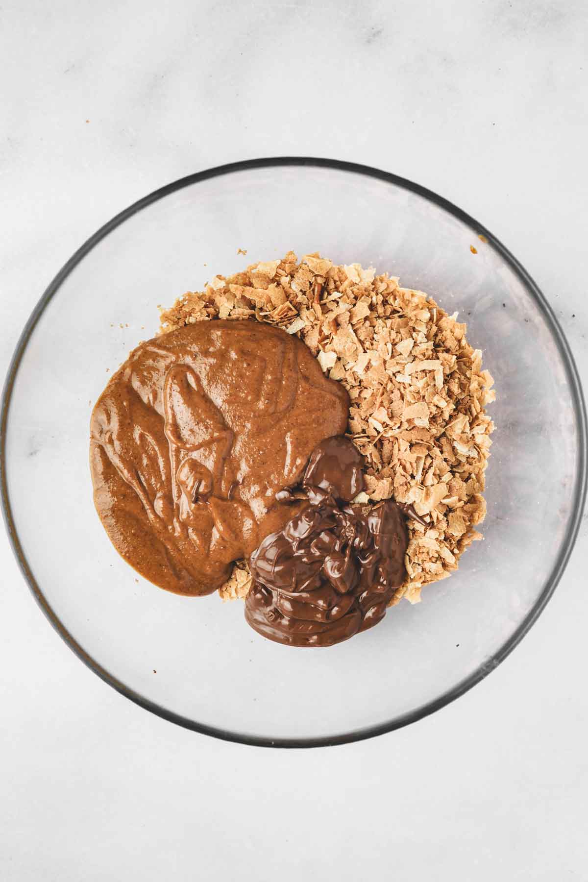 mixing bowl with feuilletine flakes, hazelnut praline paste and melted milk chocolate