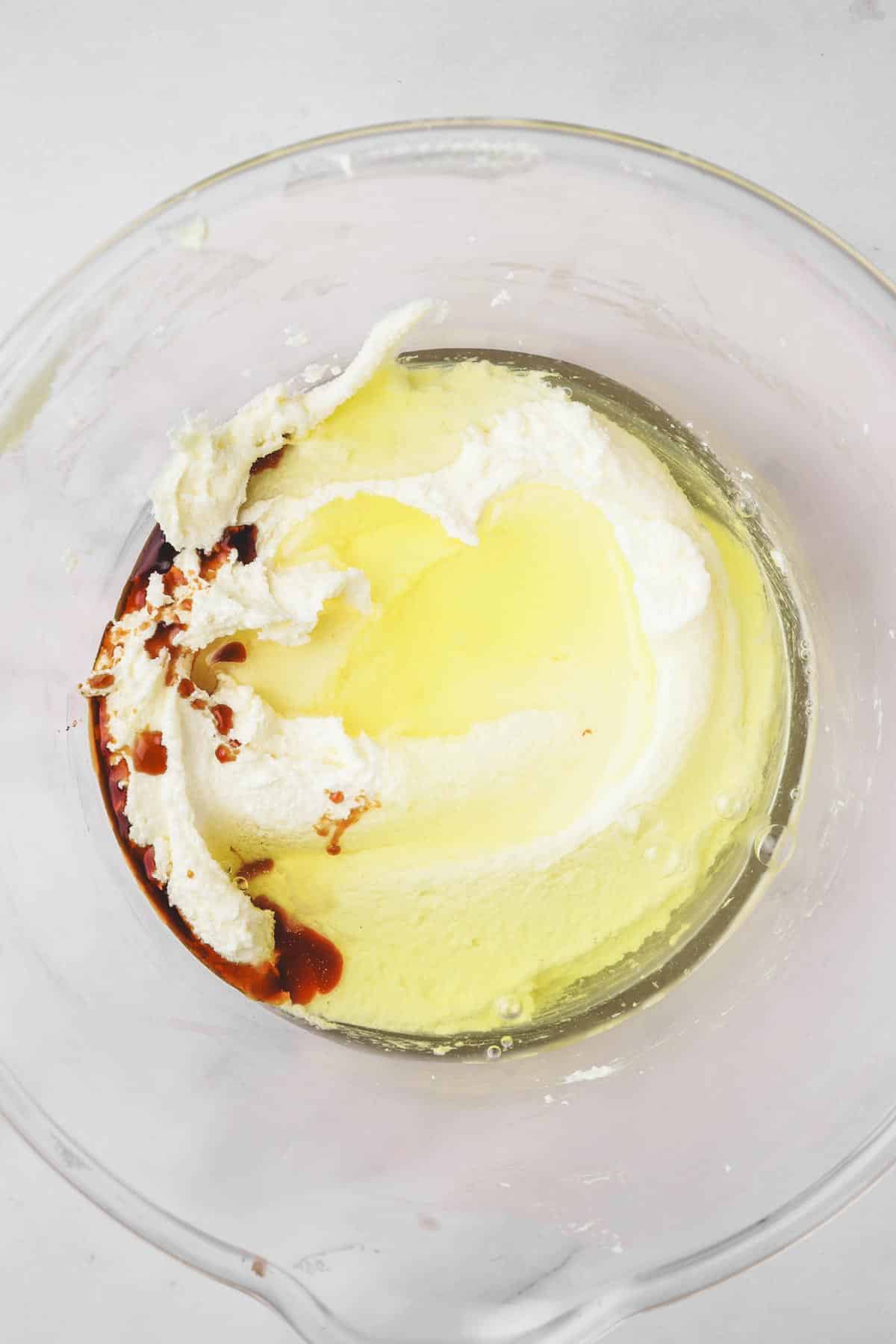 large bowl with egg white and vanilla extract