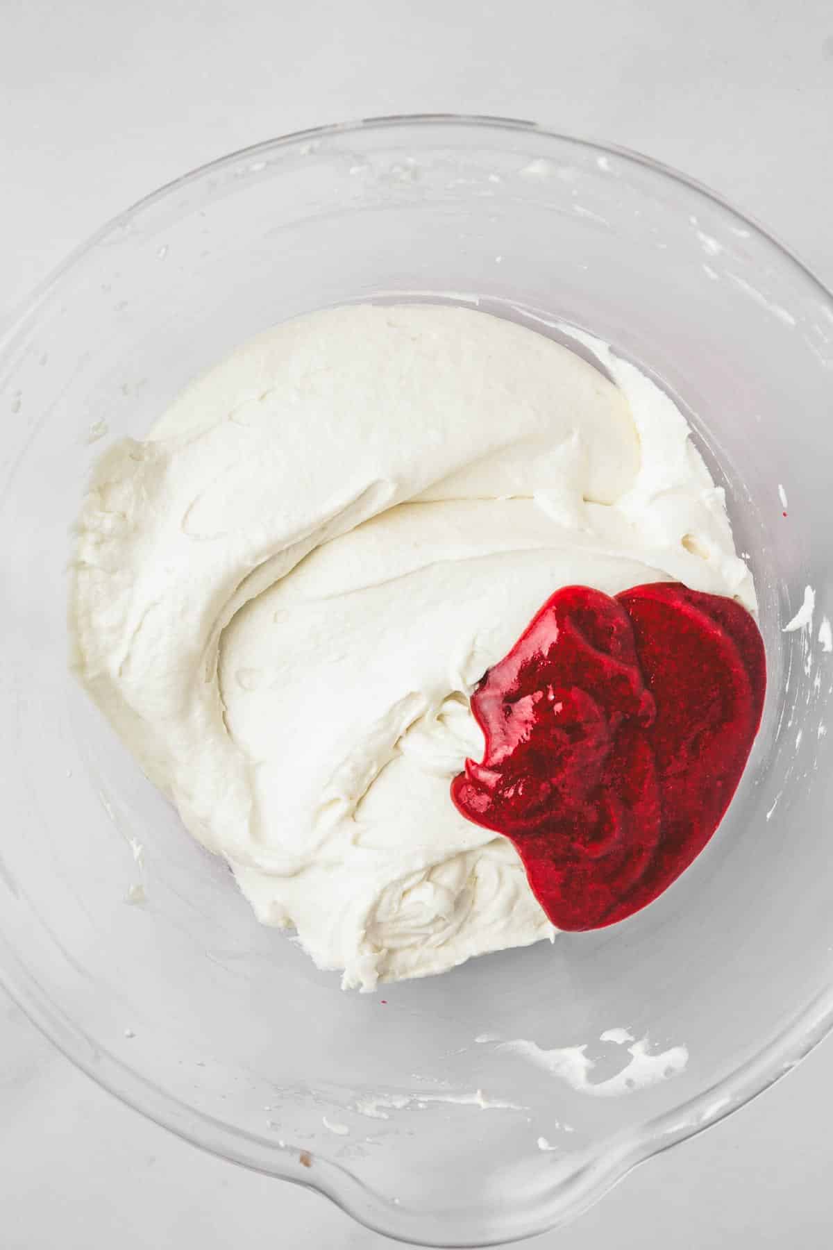 mixing bowl with cake batter and raspberry mixture