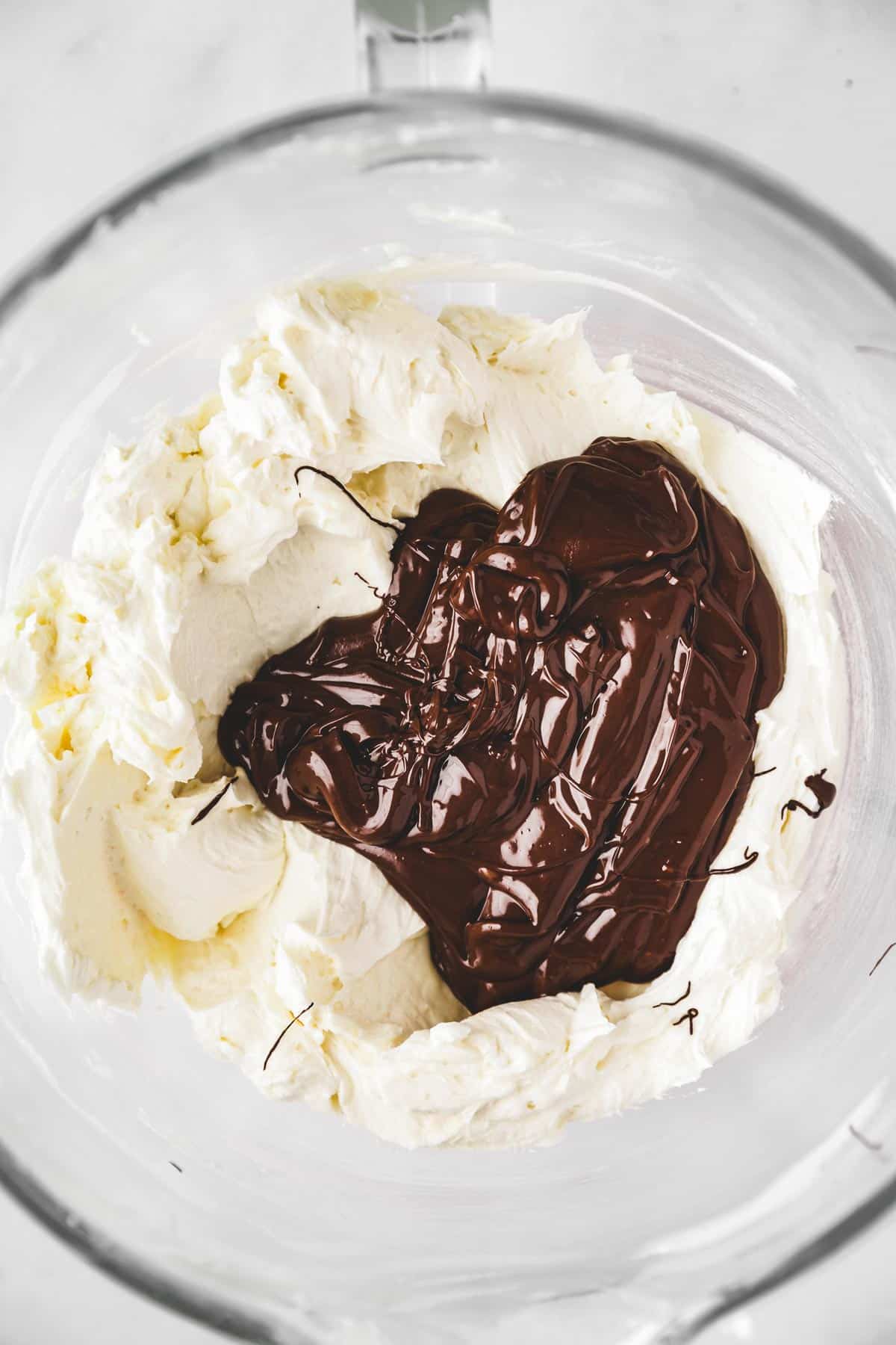 large bowl with buttercream and melted chocolate