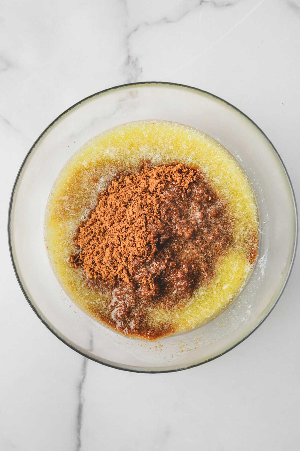 medium bowl with melted butter and biscoff cookie crumbs