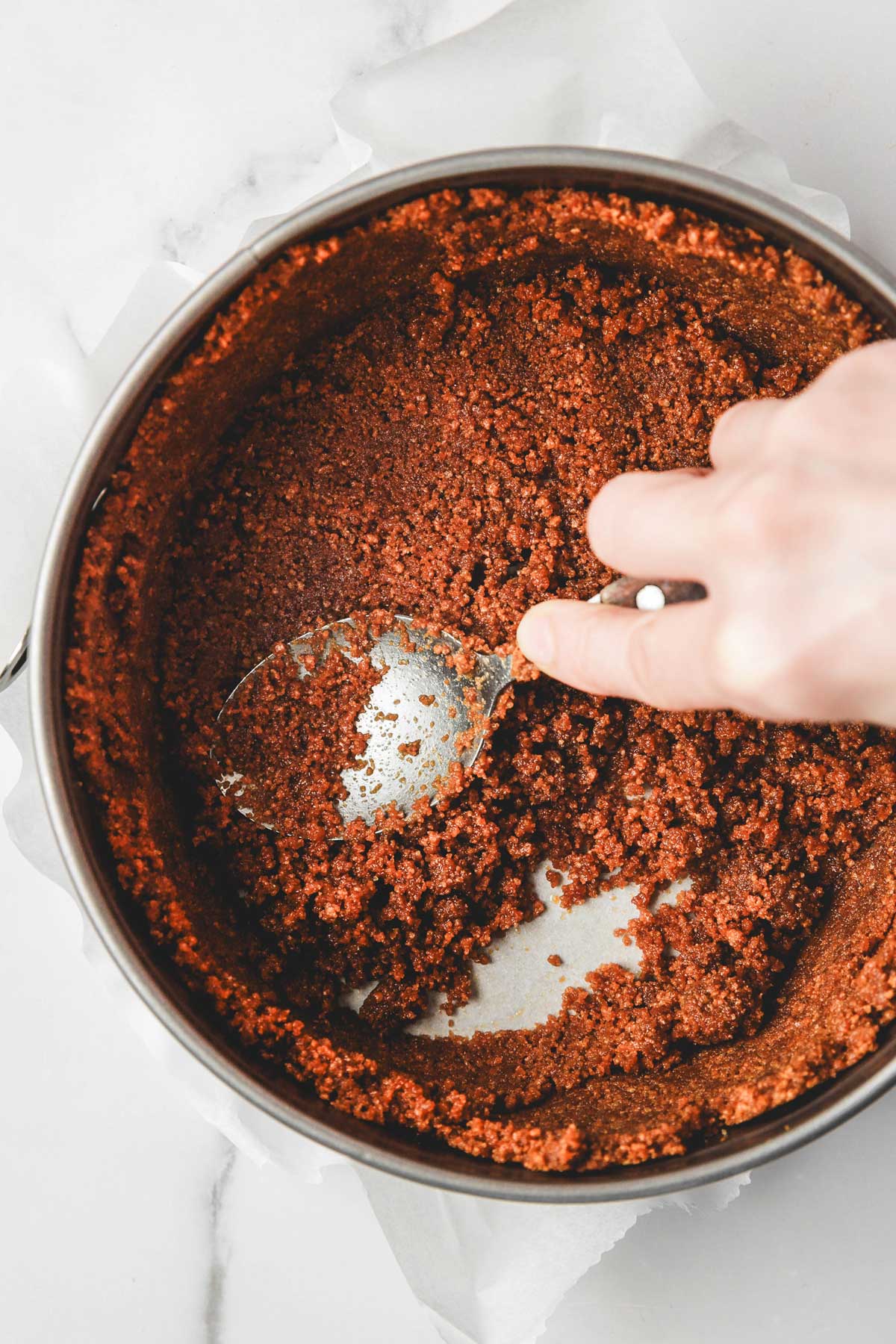 biscoff crust pressed evenly into the bottom of the pan