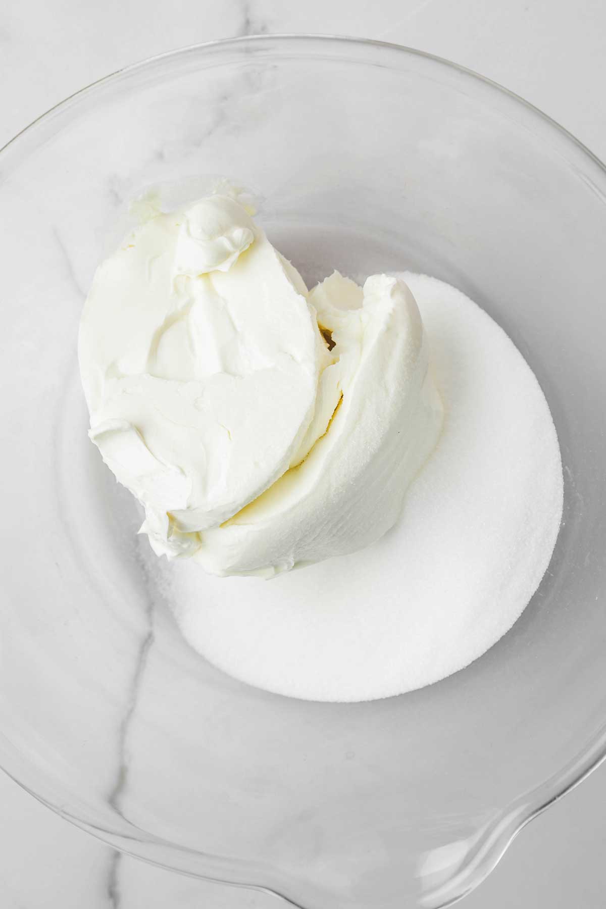 large mixing bowl with cream cheese and sugar