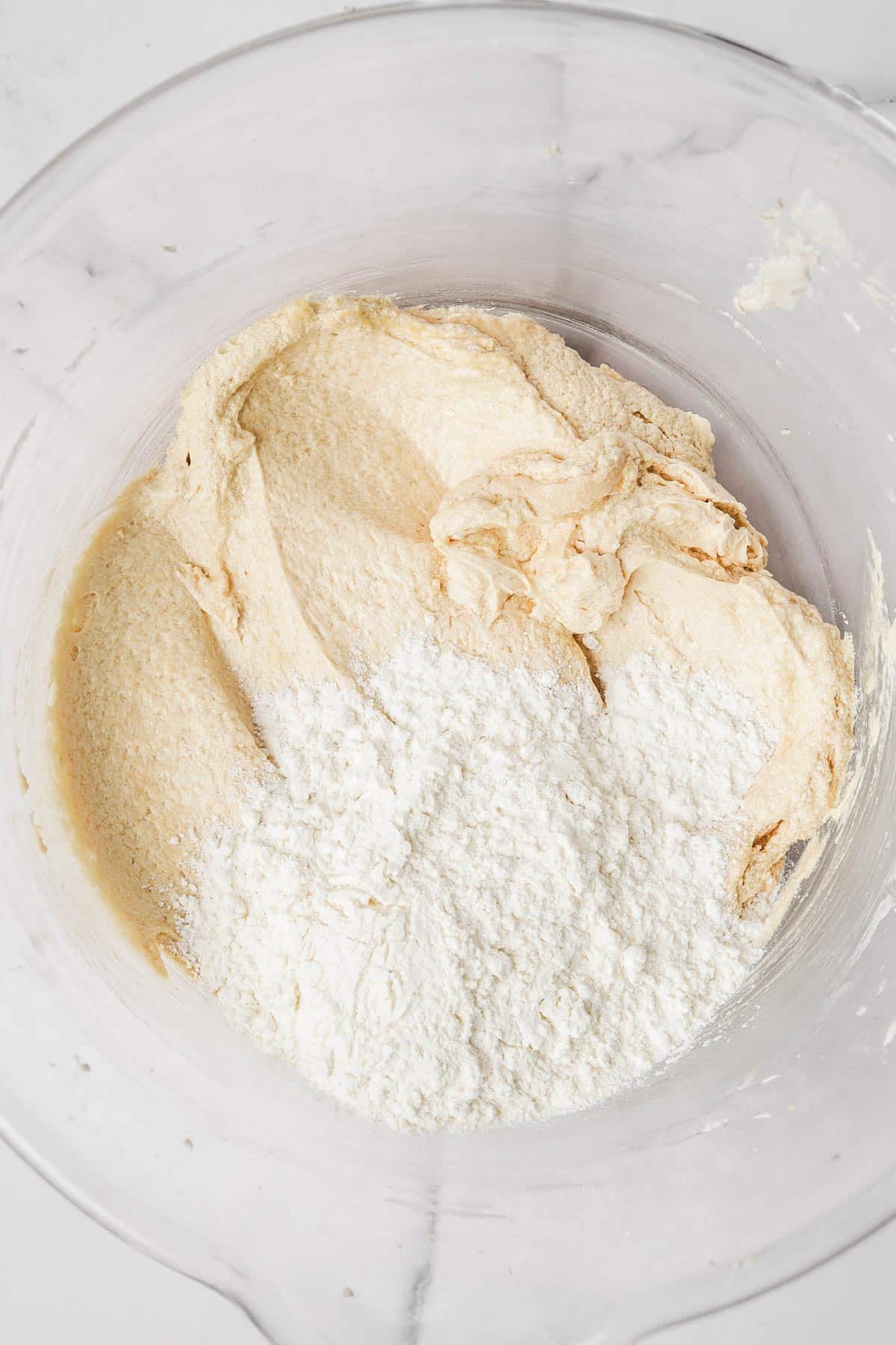 mixing bowl with cake batter and flour mixture