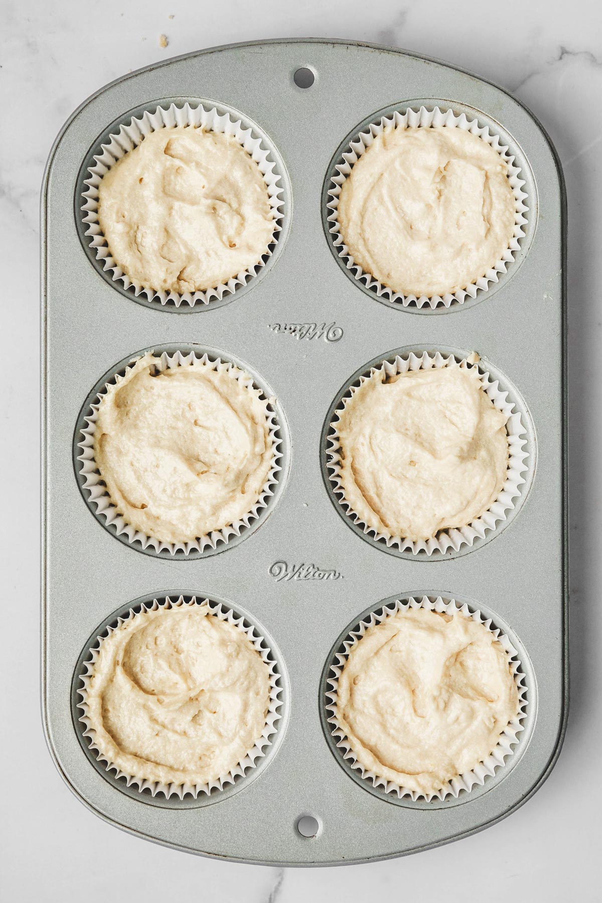 muffin tin with cupcake batter