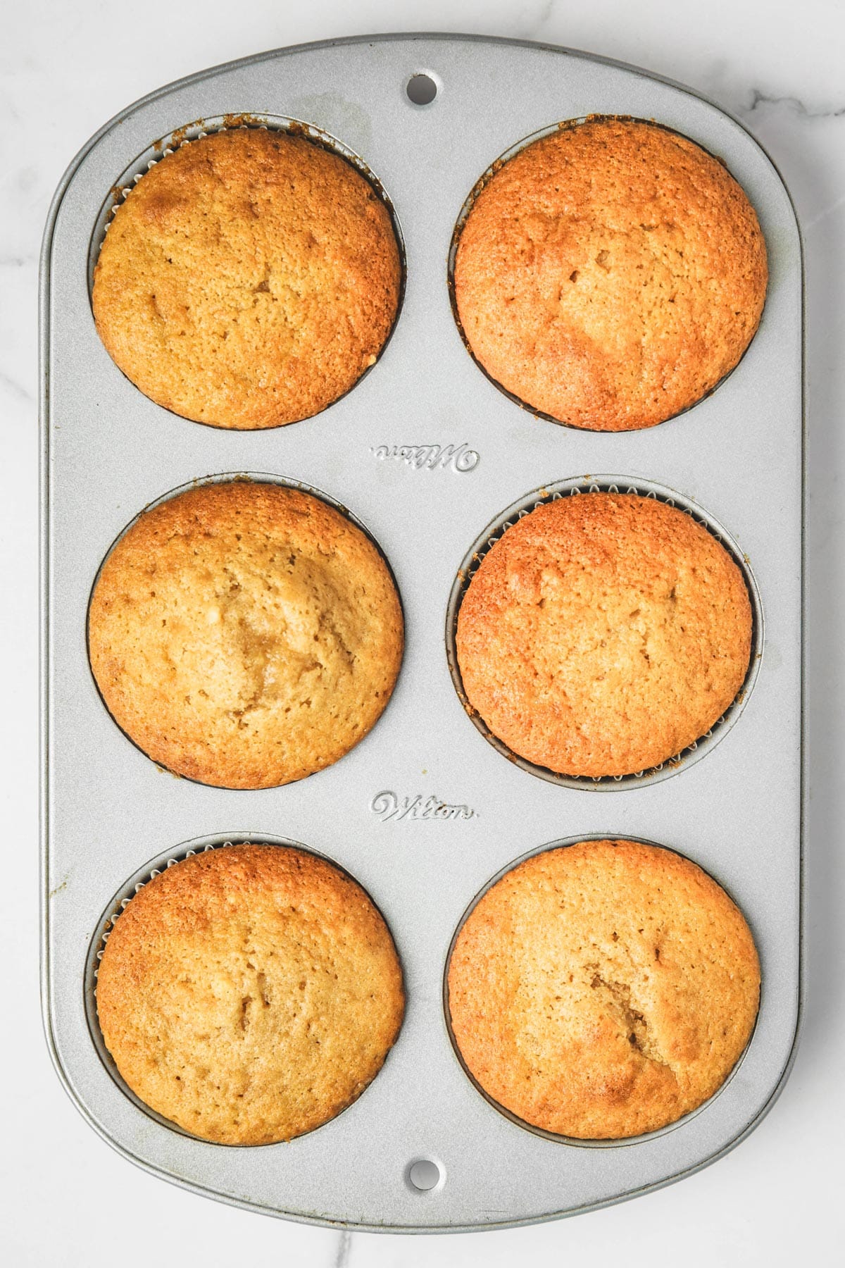 muffin pan with baked cupcakes