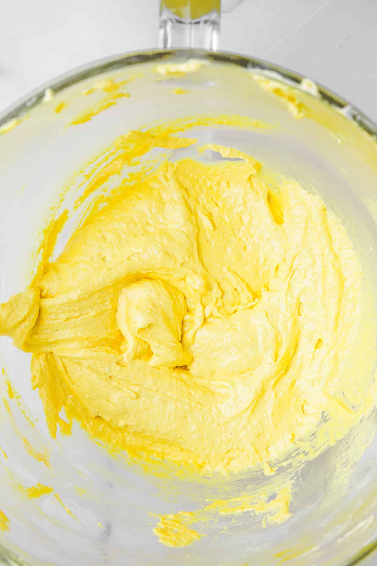 large mixing bowl with lemon macaron batter