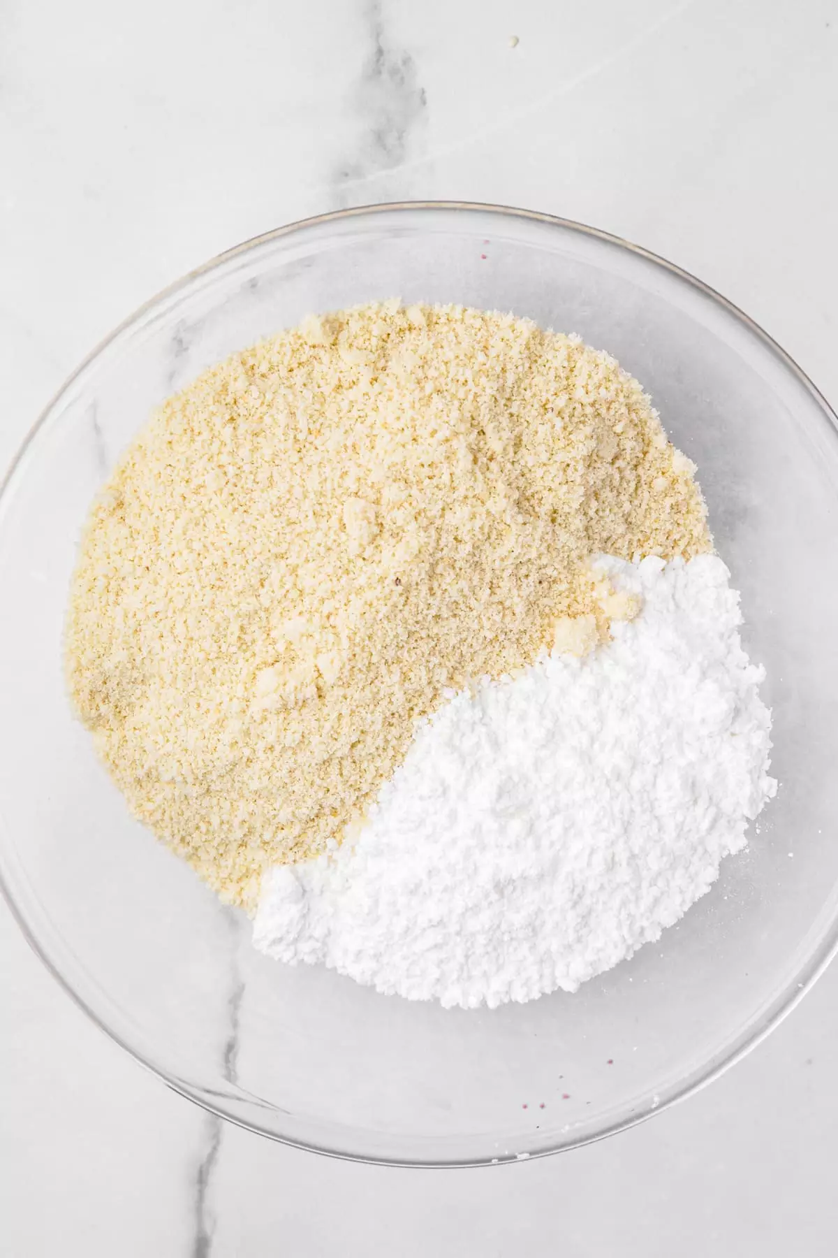 mixing bowl with almond flour and powdered sugar