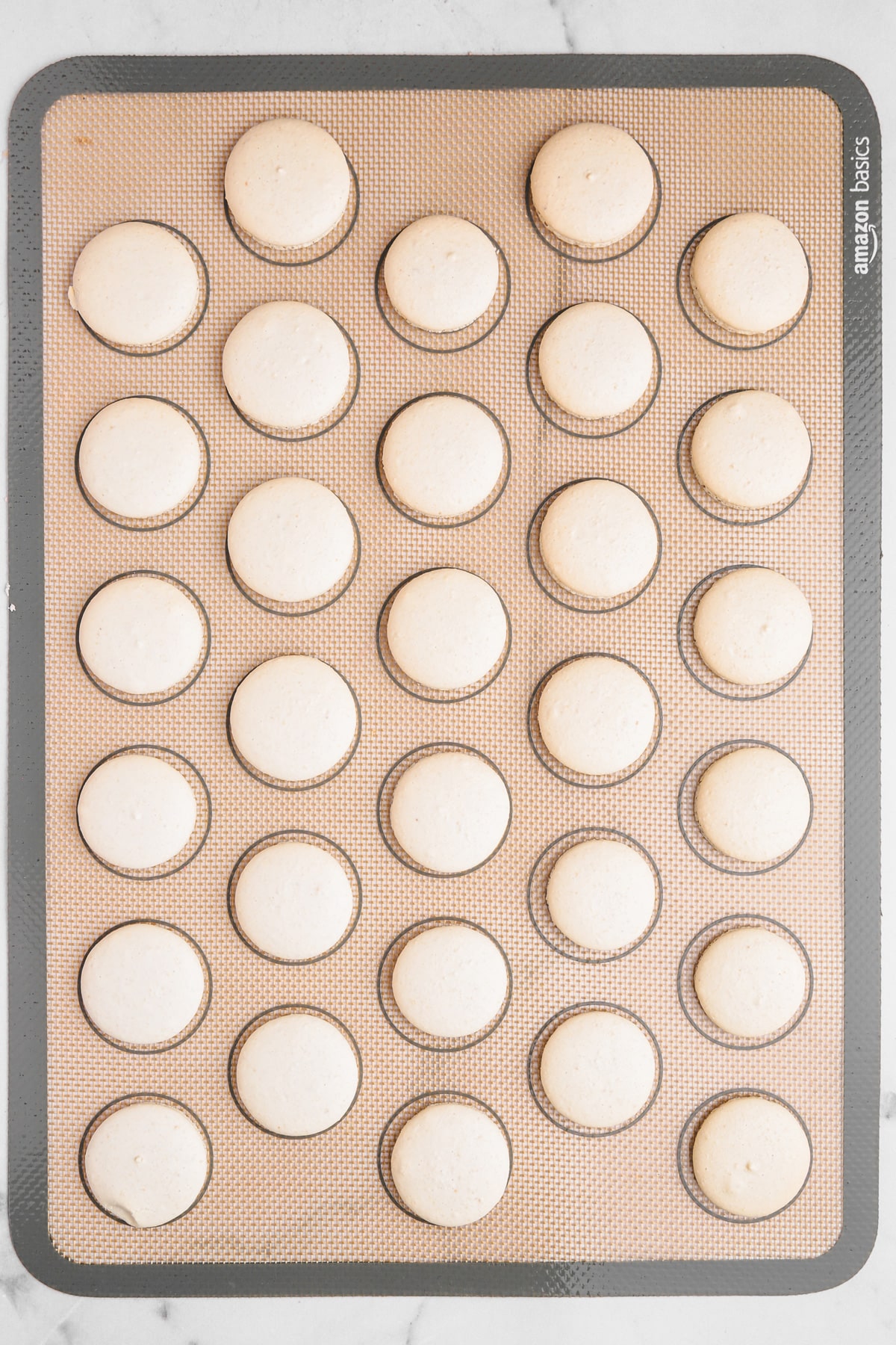 silicon baking mat with baked macarons