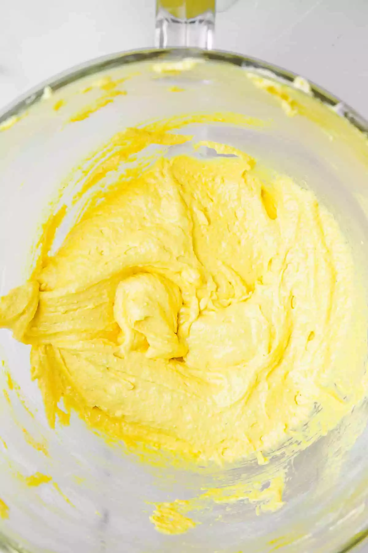 large mixing bowl with lemon macaron batter