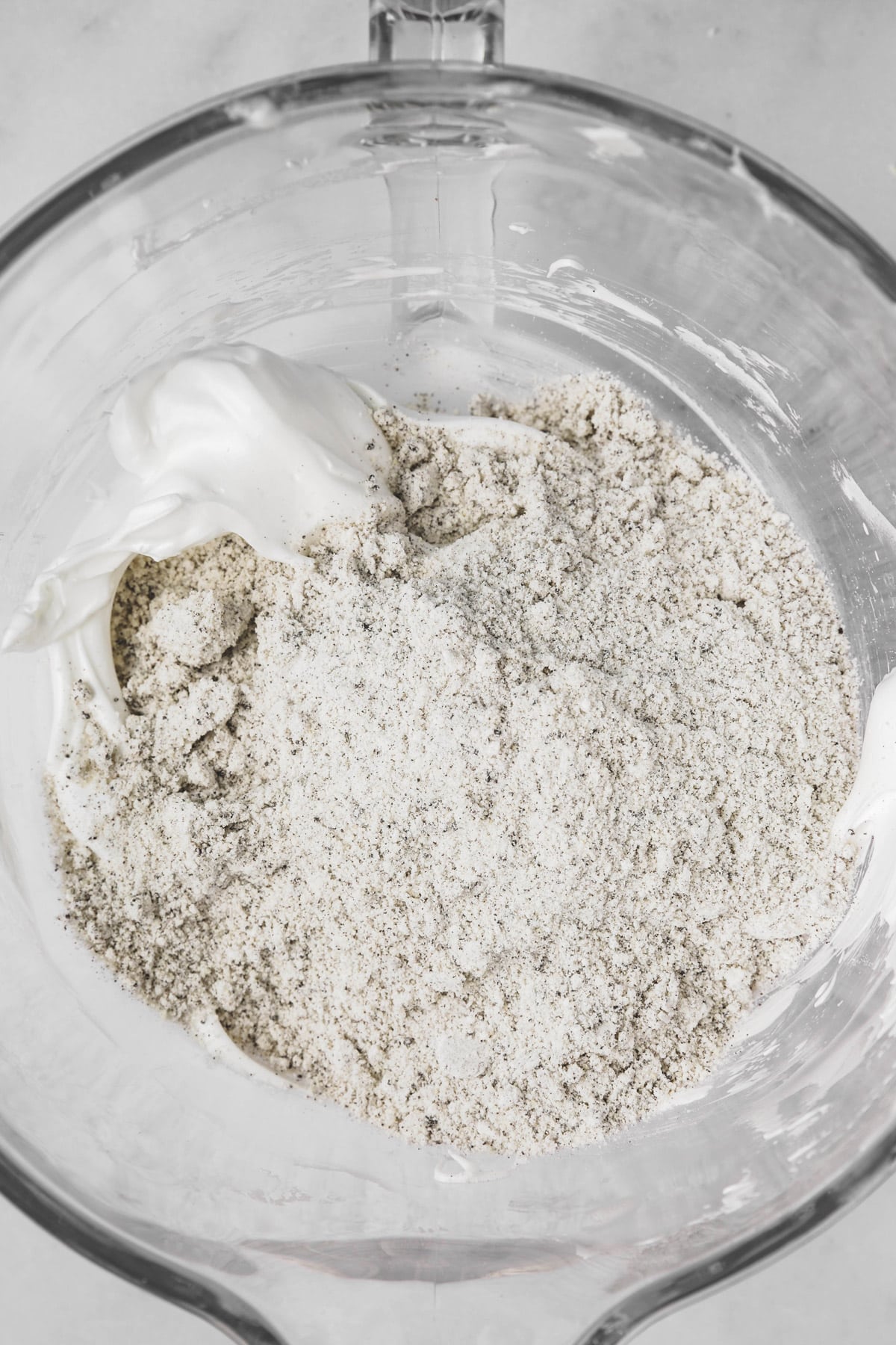 folding almond flour mixture into whipped egg whites