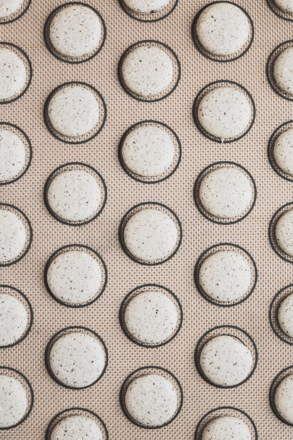 baking mat with baked oreo macarons