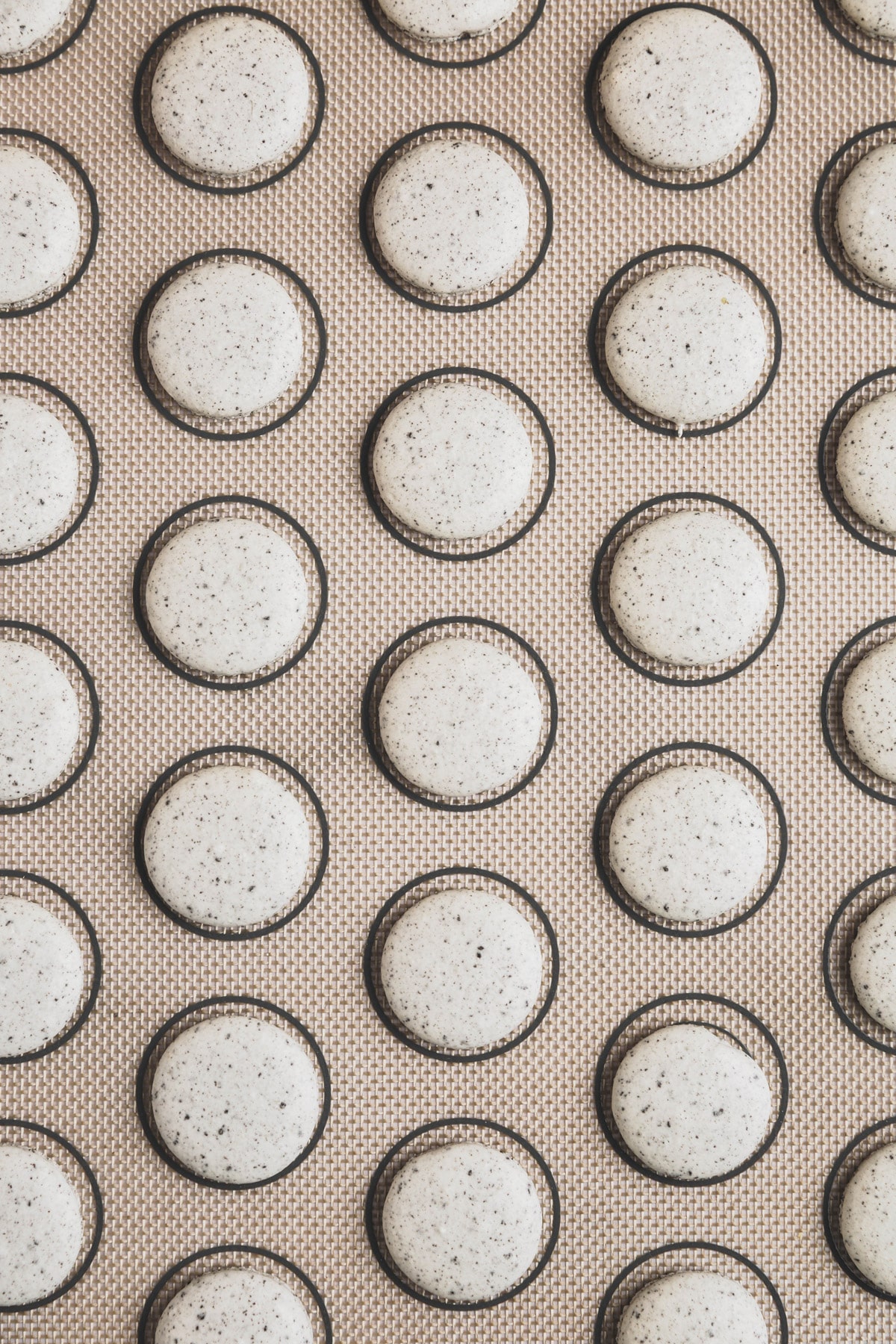 baking mat with baked oreo macarons