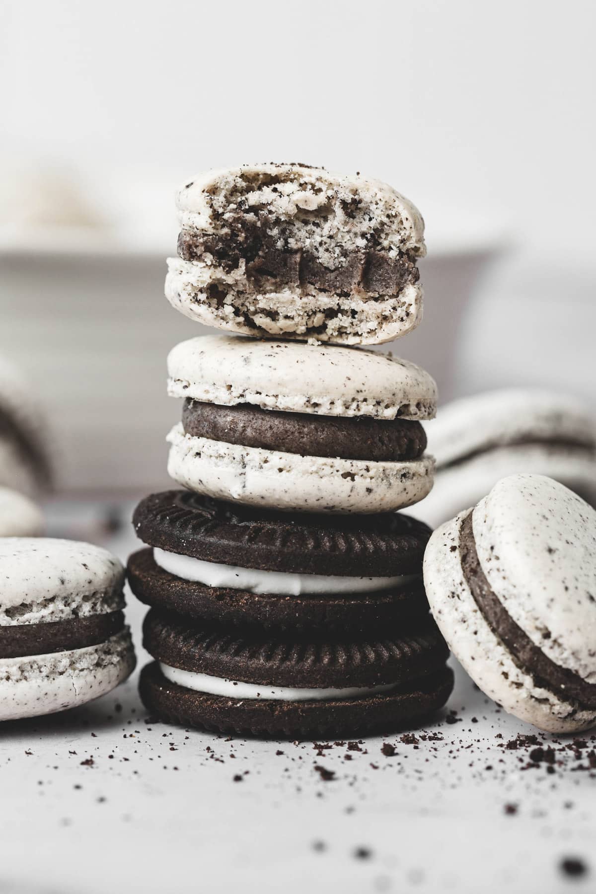 Oreo cookies and cream macarons stacked on a plate