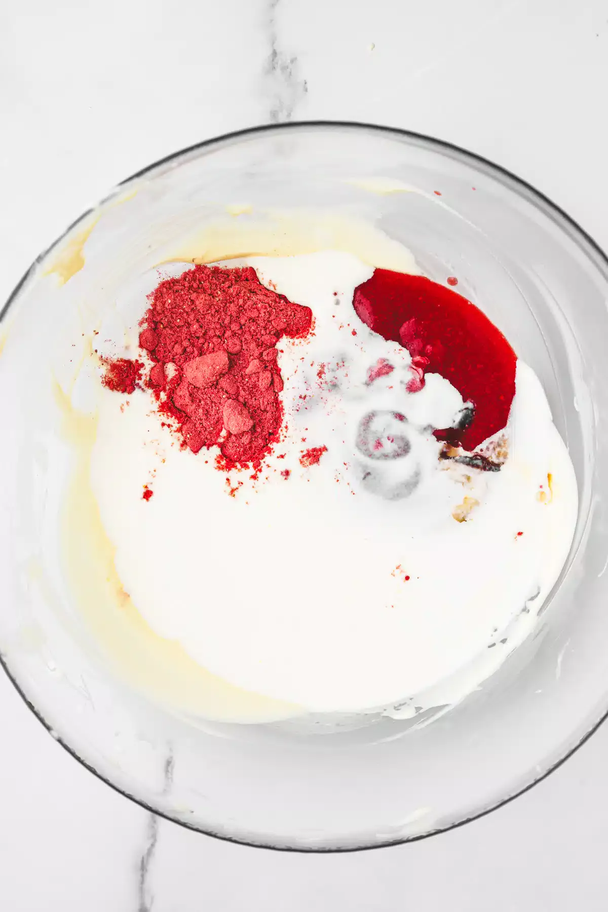 medium bowl with melted white chocolate with strawberry puree