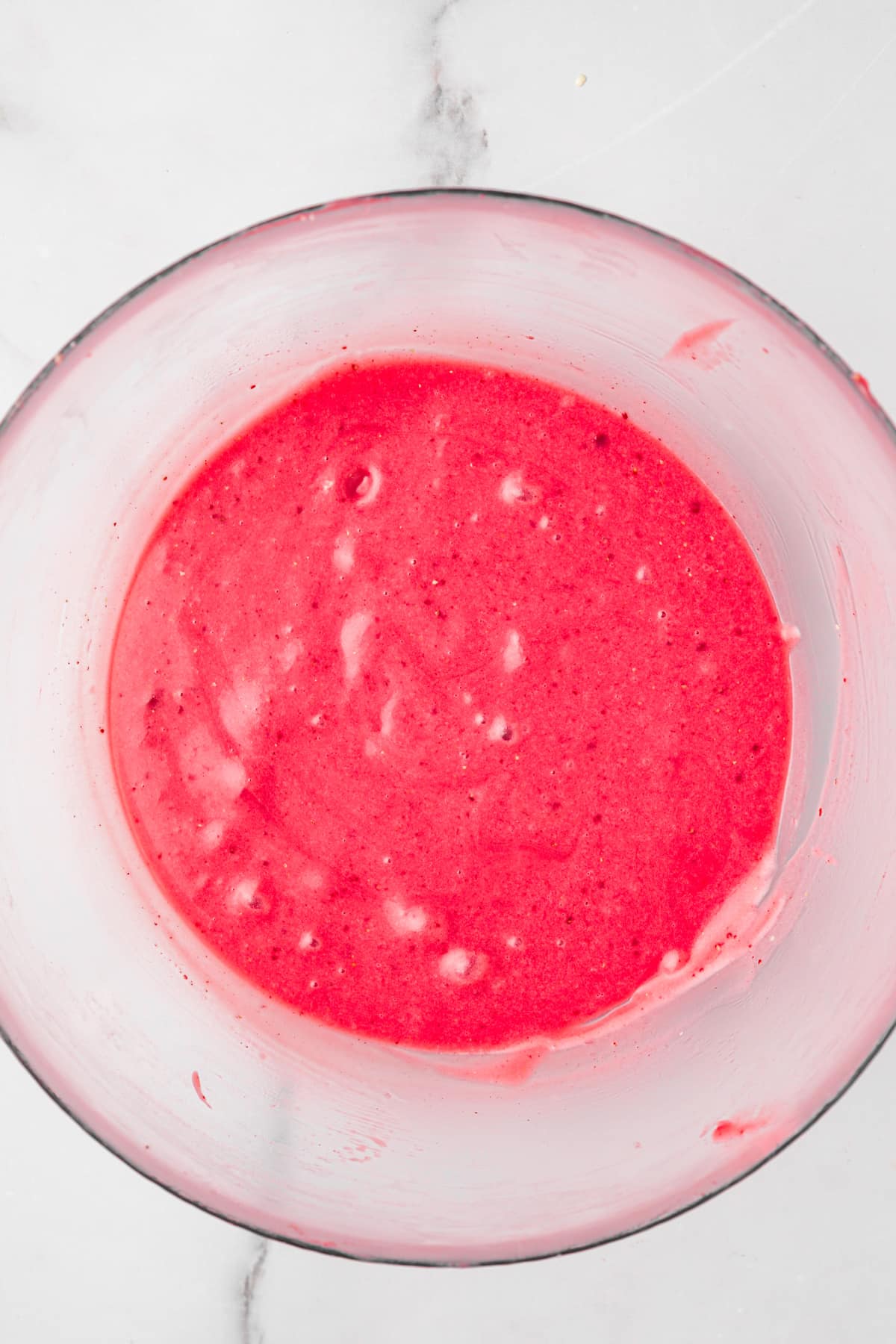 melted strawberry ganache on a medium bowl
