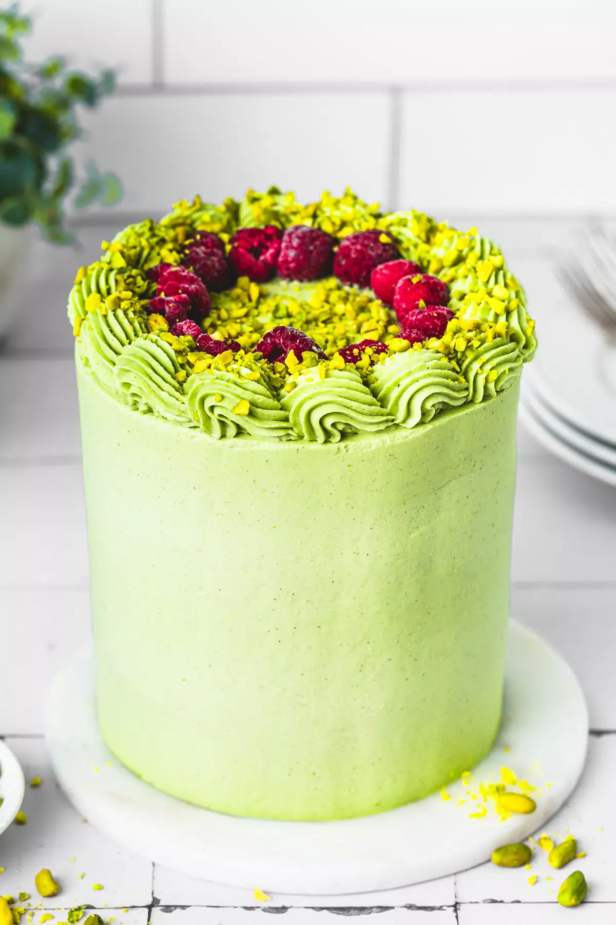 layer cake pistache et framboise sur une table