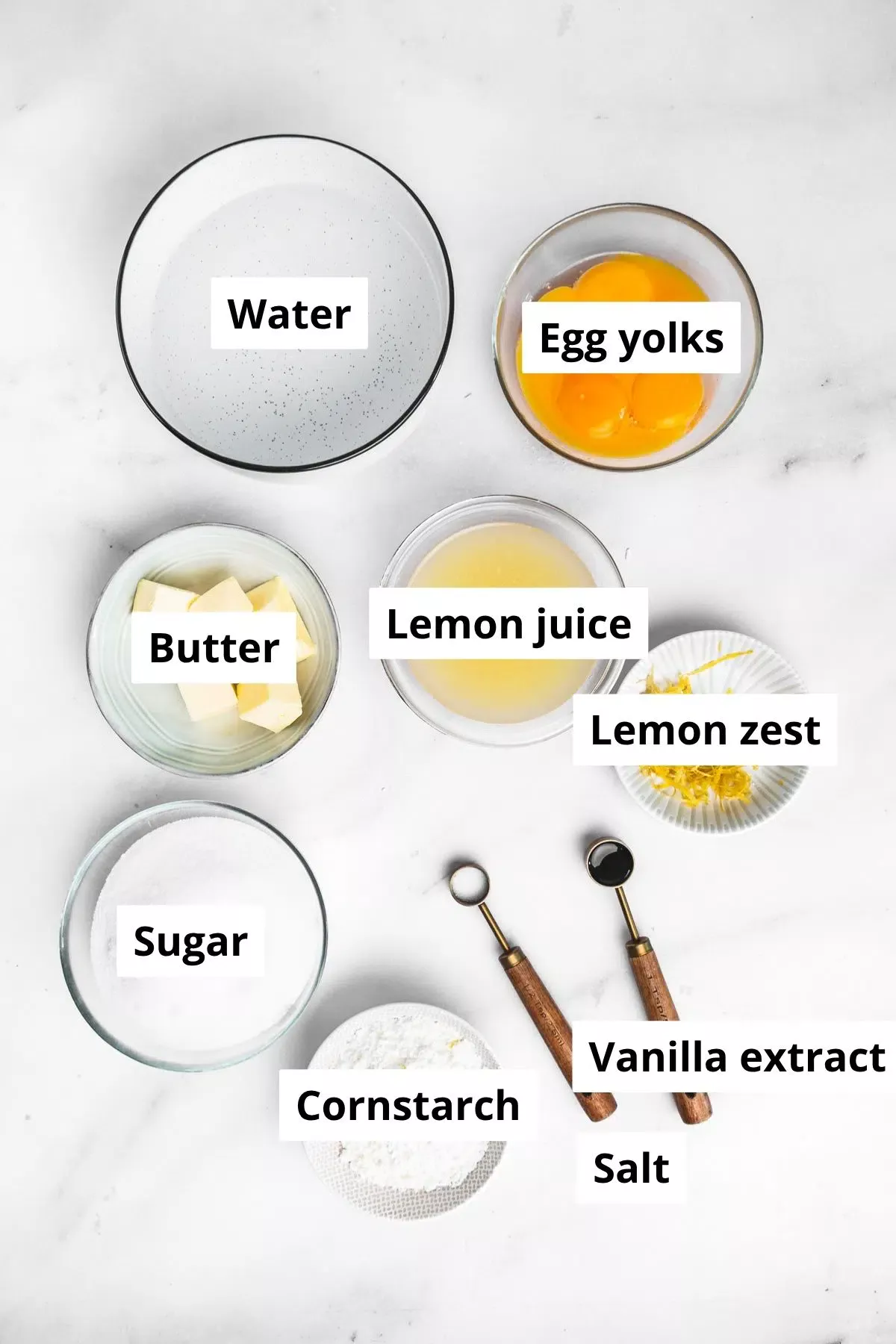 ingredients for lemon meringue pie filling in bowls on a kitchen counter