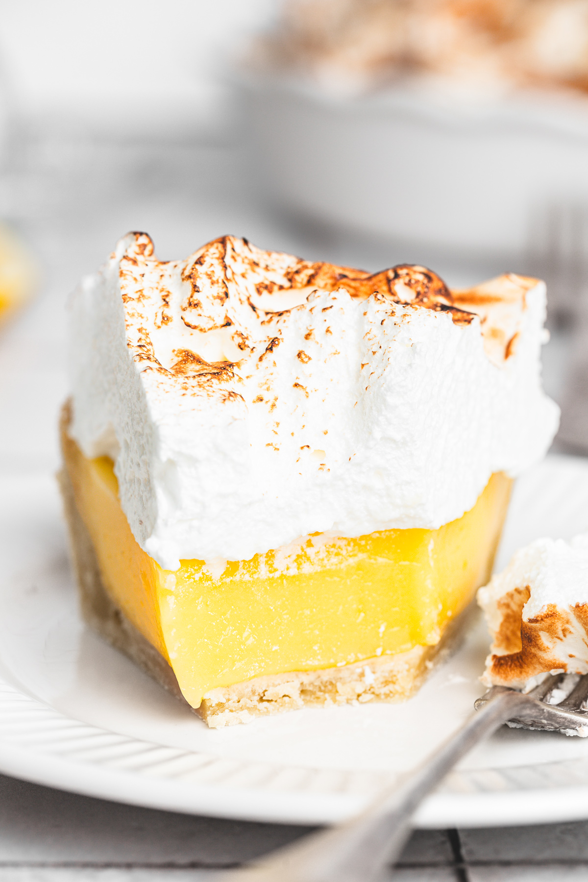 sliced lemon meringue pie on a table