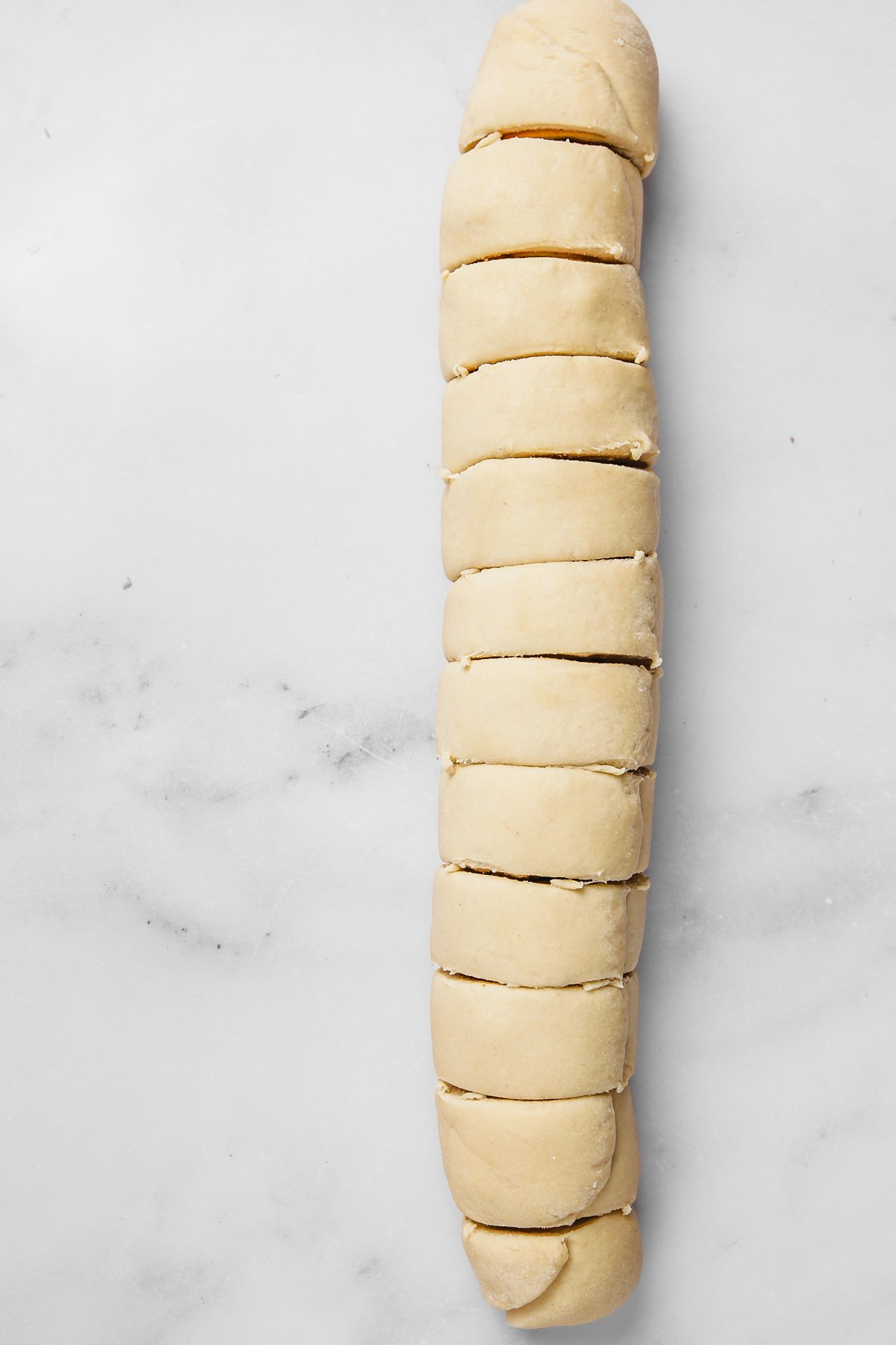 Biscoff roll log sliced into even rolls with visible cookie butter filling