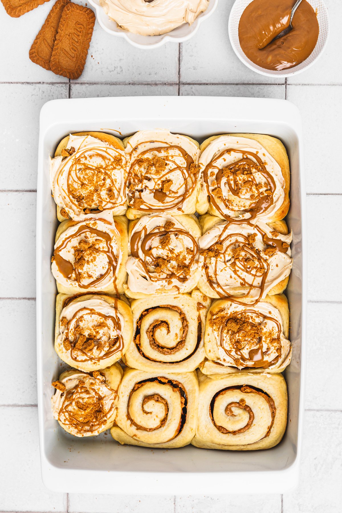 Biscoff cinnamon rolls baked in a dish on a wooden table